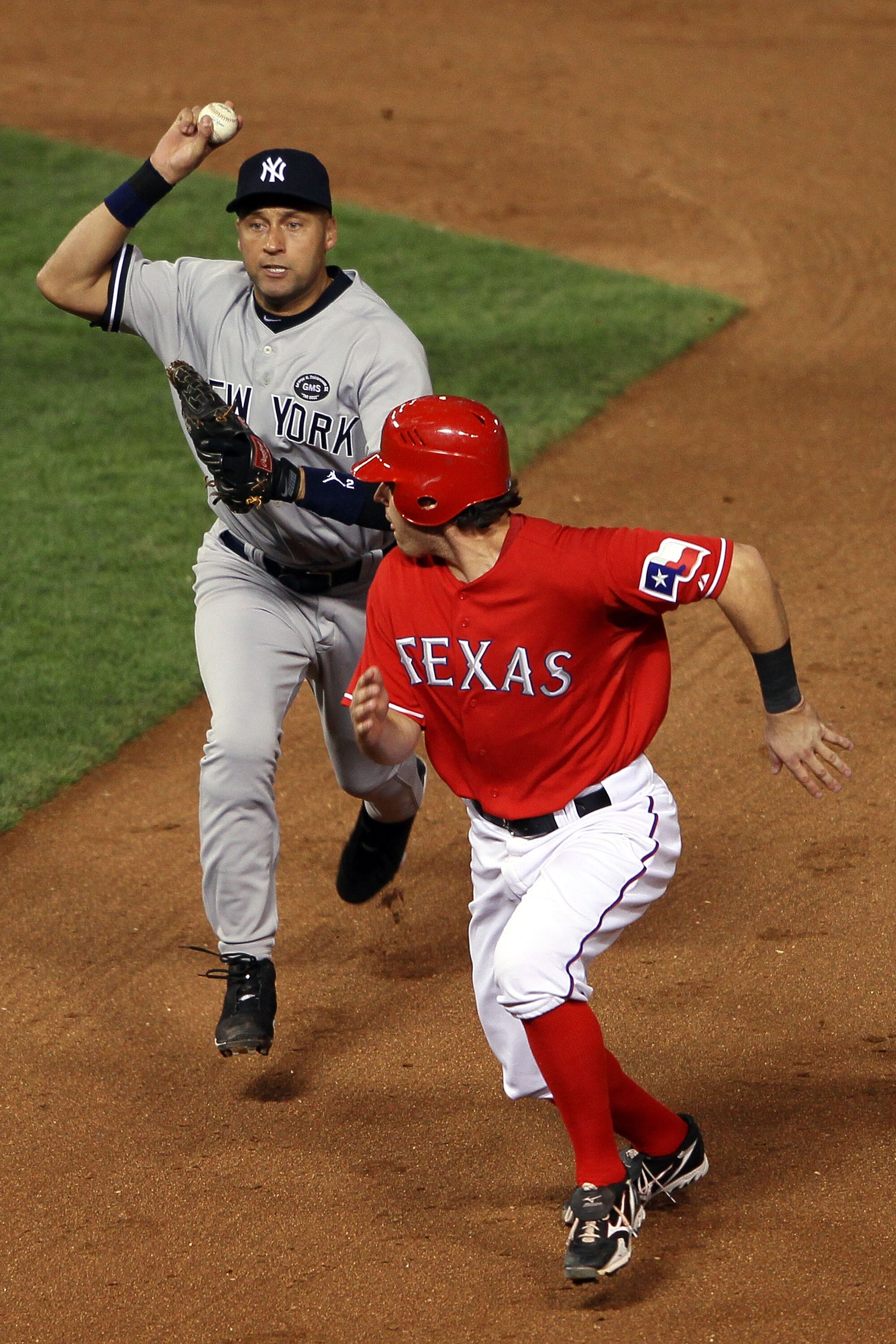 ARLINGTON, TX - OCTOBER 15:  Ian Kinsler #5 of the Texas Rangers is caught in a run down attempting to steal second base against Derek Jeter #2 of the New York Yankees in Game One of the ALCS during the 2010 MLB Playoffs at Rangers Ballpark in Arlington o