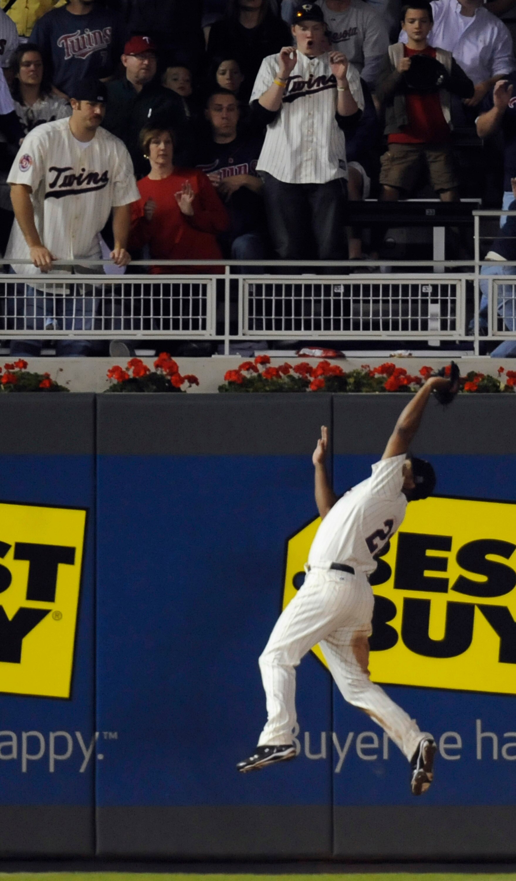 MINNEAPOLIS, MN - OCTOBER 7: Left fielder Delmon Young #21 of the Minnesota Twins makes a leaping catch in the ninth inning during game two of the ALDS game against the New York Yankees on October 7, 2010 at Target Field in Minneapolis, Minnesota. (Photo