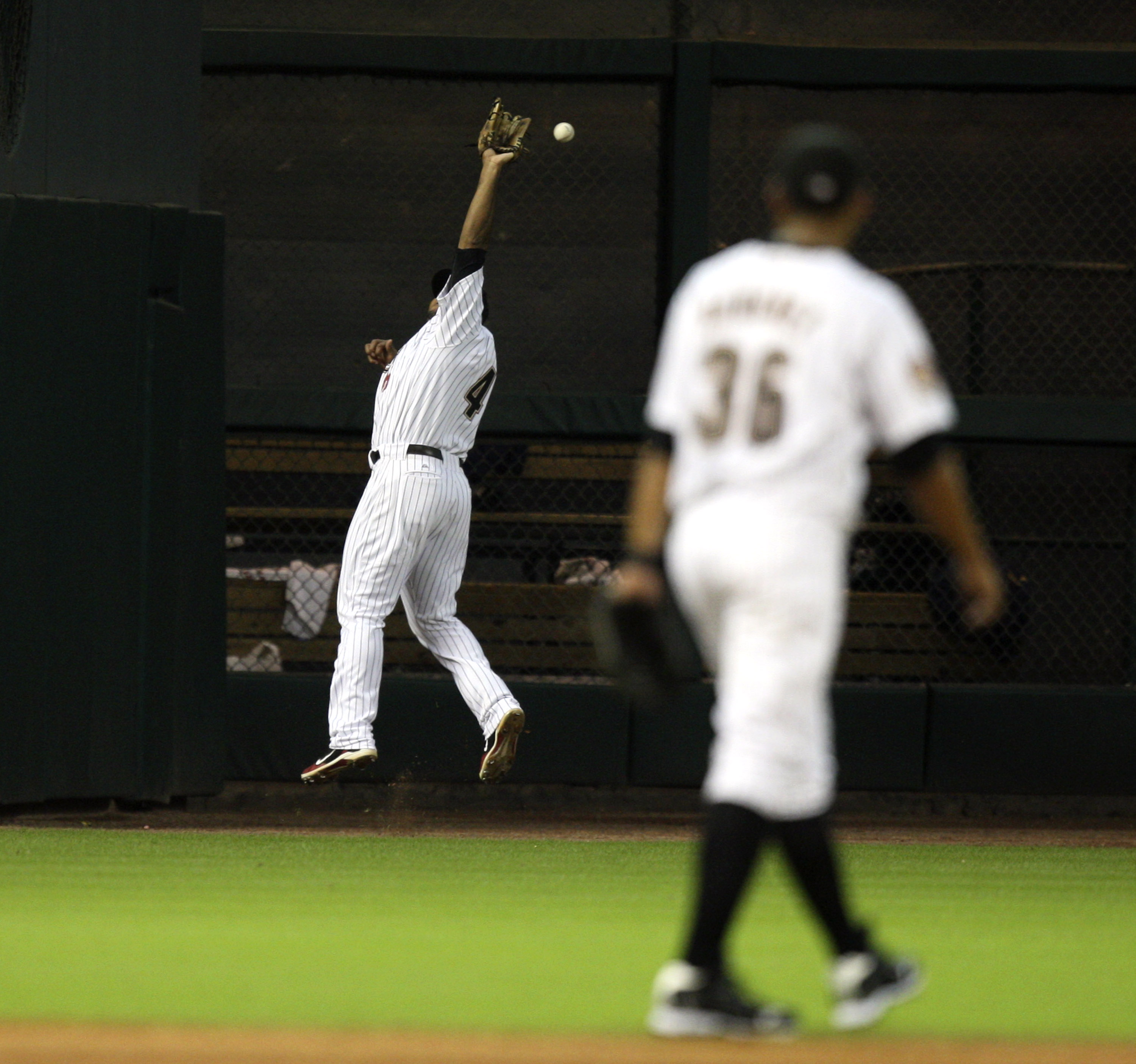 HOUSTON - JULY 30:  Left fielder Carlos Lee #45 makes a leaping attempt on a ball hit by Casey McGehee of the Milwaukee Brewers in the fourth inning at Minute Maid Park on July 30, 2010 in Houston, Texas.  (Photo by Bob Levey/Getty Images)