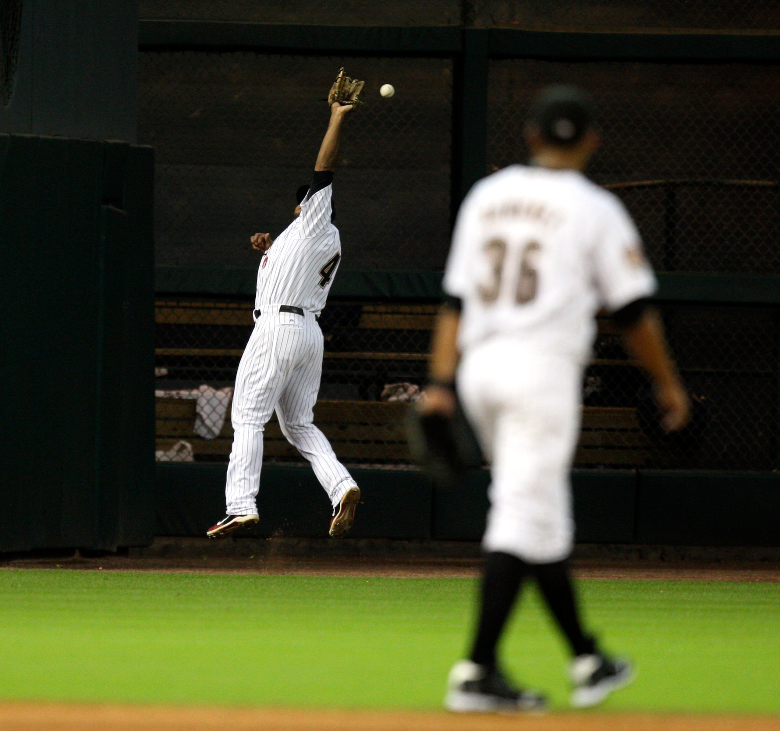 HOUSTON - JULY 30:  Left fielder Carlos Lee #45 makes a leaping attempt on a ball hit by Casey McGehee of the Milwaukee Brewers in the fourth inning at Minute Maid Park on July 30, 2010 in Houston, Texas.  (Photo by Bob Levey/Getty Images)