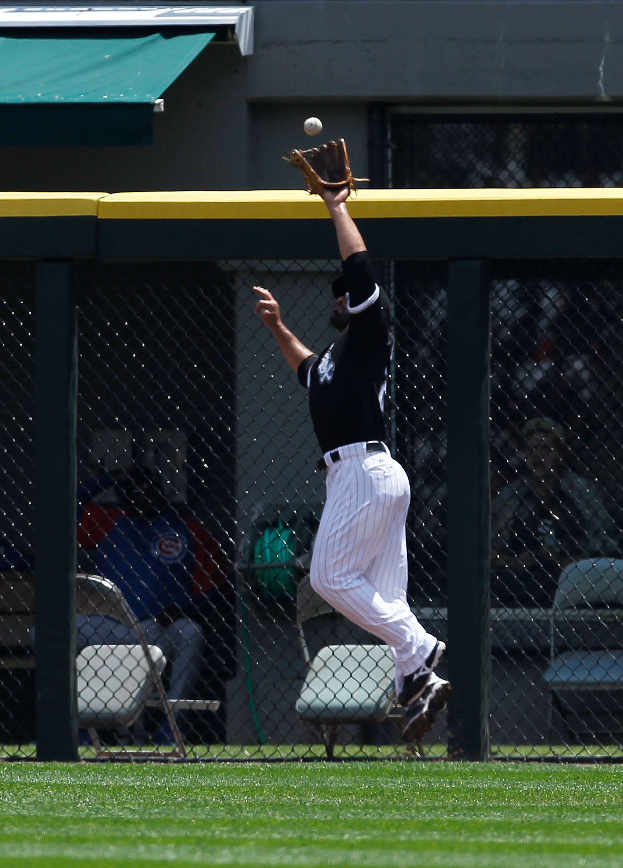 CHICAGO - JUNE 27: Carlos Quentin #20 of the Chicago White Sox leaps to catch a fly ball at the fence against the Chicago Cubs at U.S. Cellular Field on June 27, 2010 in Chicago, Illinois. The Cubs defeated the White Sox 8-6. (Photo by Jonathan Daniel/Get