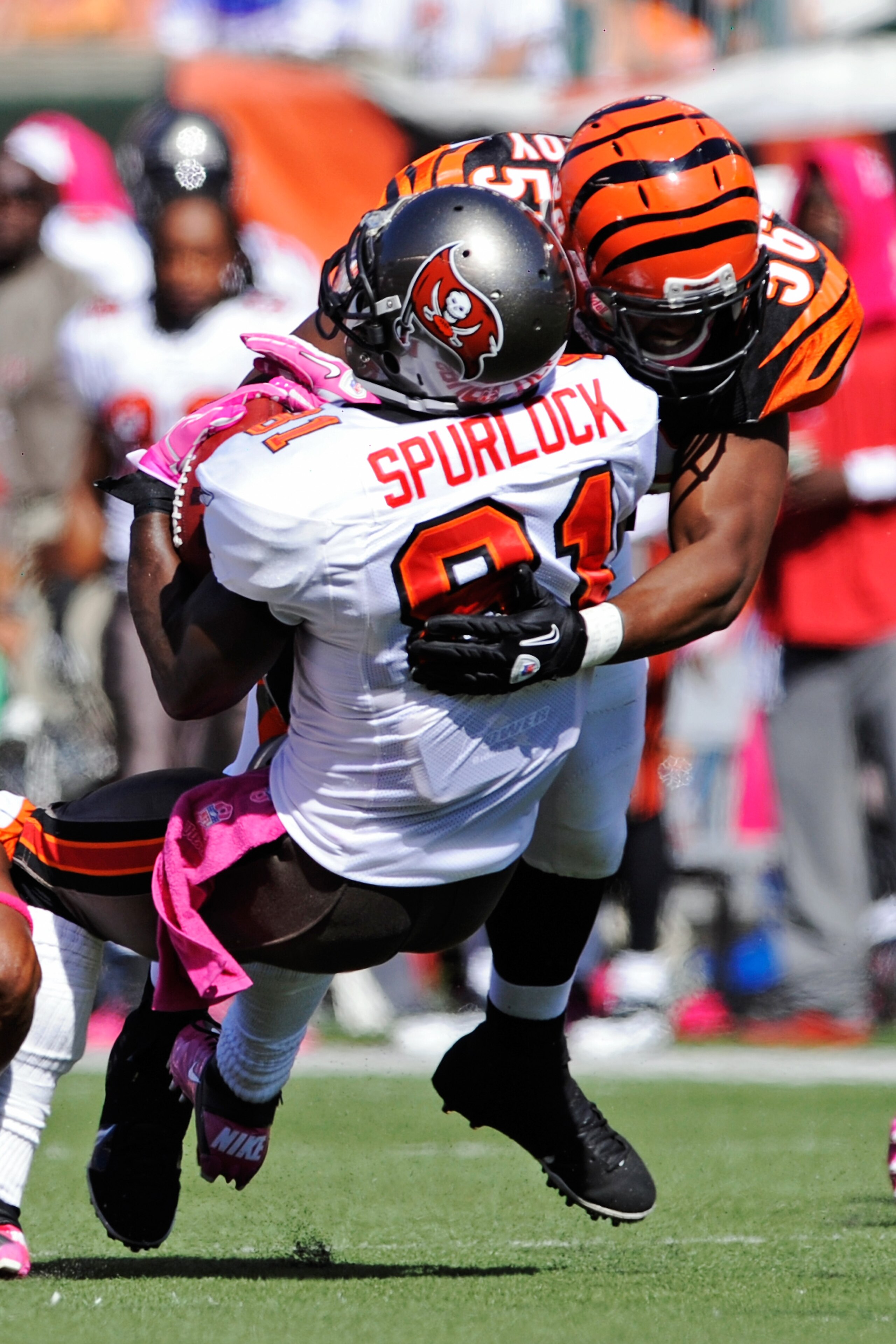 CINCINNATI, OH - OCTOBER 10:  Michael Spurlock #81of the Tampa Bay Buccaneers is flattened by Roddrick Muckelroy #56 of the Cincinnati Bengals during a kickoff return at Paul Brown Stadium on October 10, 2010 in Cincinnati, Ohio.  (Photo by Jamie Sabau/Ge