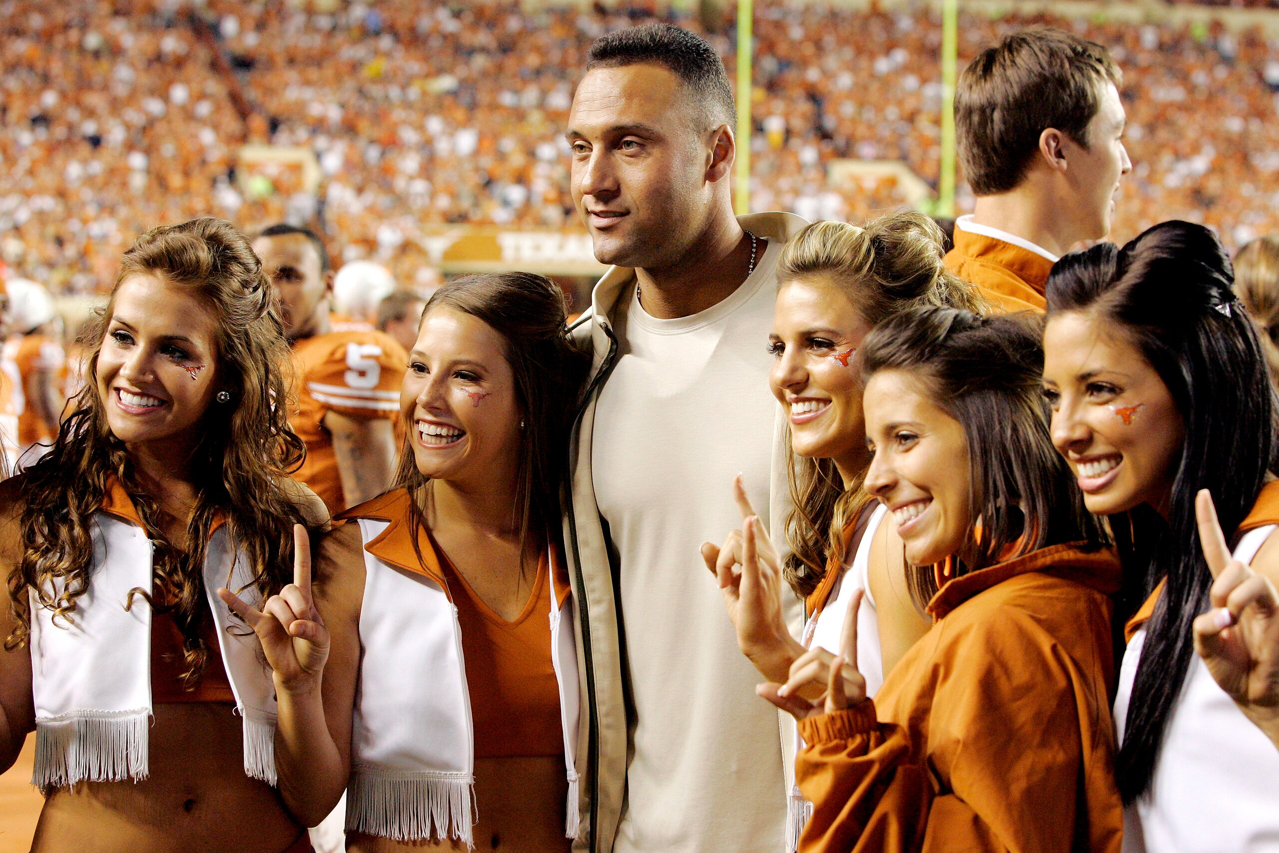 AUSTIN, TX - OCTOBER 18: Derek Jeter poses for a photo for some Texas cheerleaders during a game between the Texas Longhorns and the Missouri Tigers on October 18, 2008 at Darrell K Royal-Texas Memorial Stadium in Austin, Texas. Texas won 56-31. (Photo by