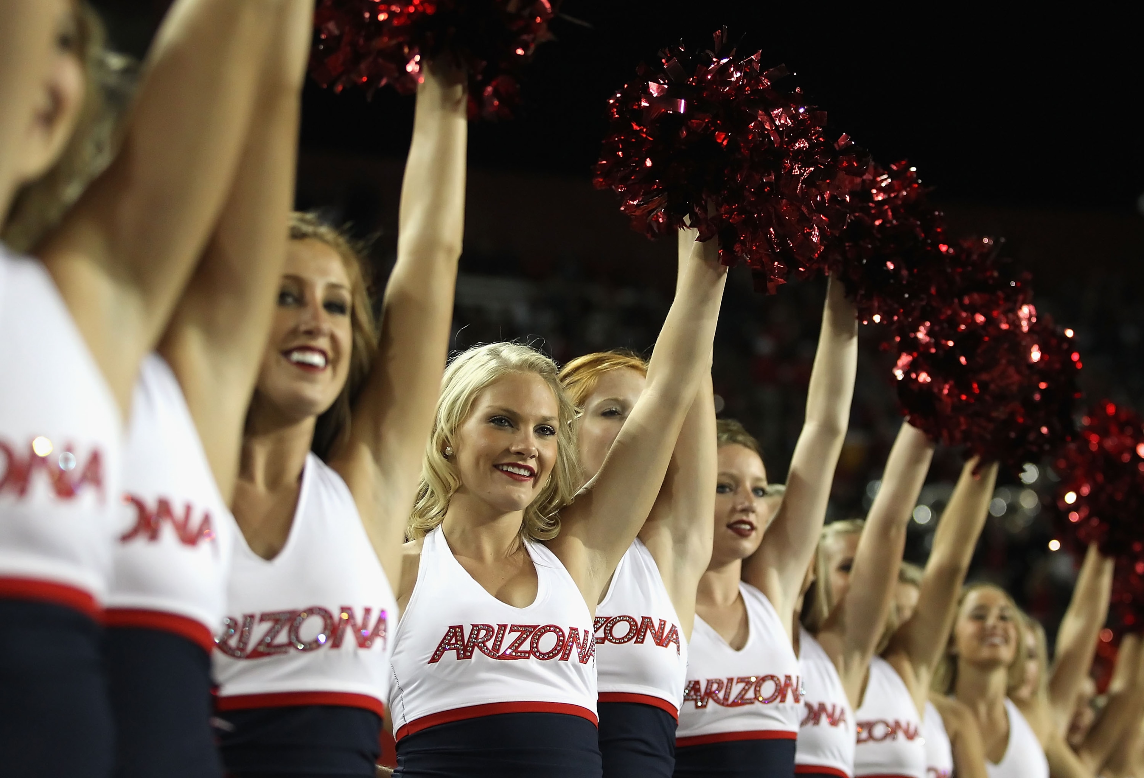 TUCSON, AZ - OCTOBER 23:  Arizona Wildcats cheerleaders peform during the college football game against the Washington Huskies at Arizona Stadium on October 23, 2010 in Tucson, Arizona.   The Wildcats defeated the Huskies 44-14.  (Photo by Christian Peter