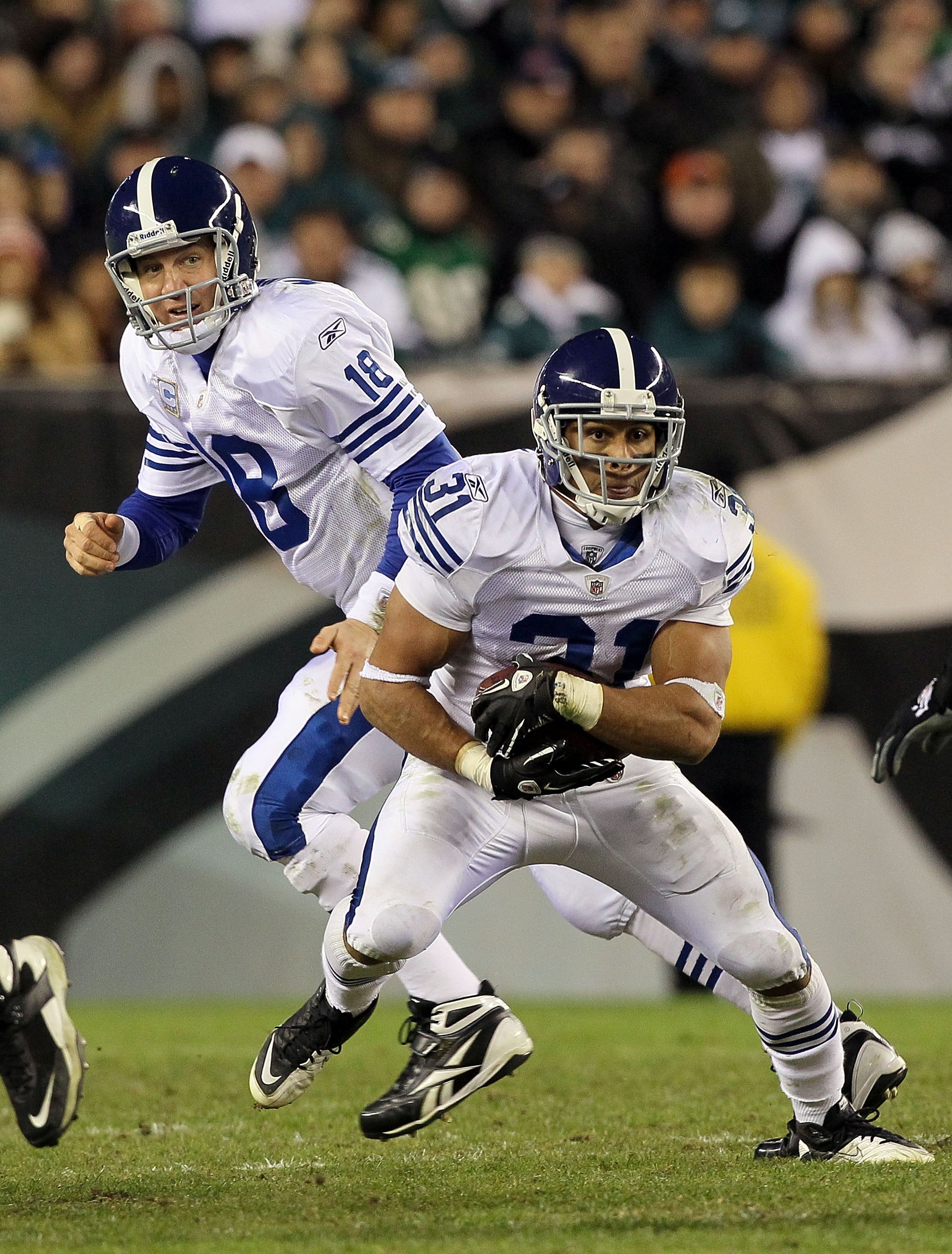 PHILADELPHIA - NOVEMBER 07:  Donald Brown #31 of the Indianapolis Colts runs the ball against the Philadelphia Eagles as teammate Peyton Manning #18 looks on on November 7, 2010 at Lincoln Financial Field in Philadelphia, Pennsylvania. The Eagles defeated
