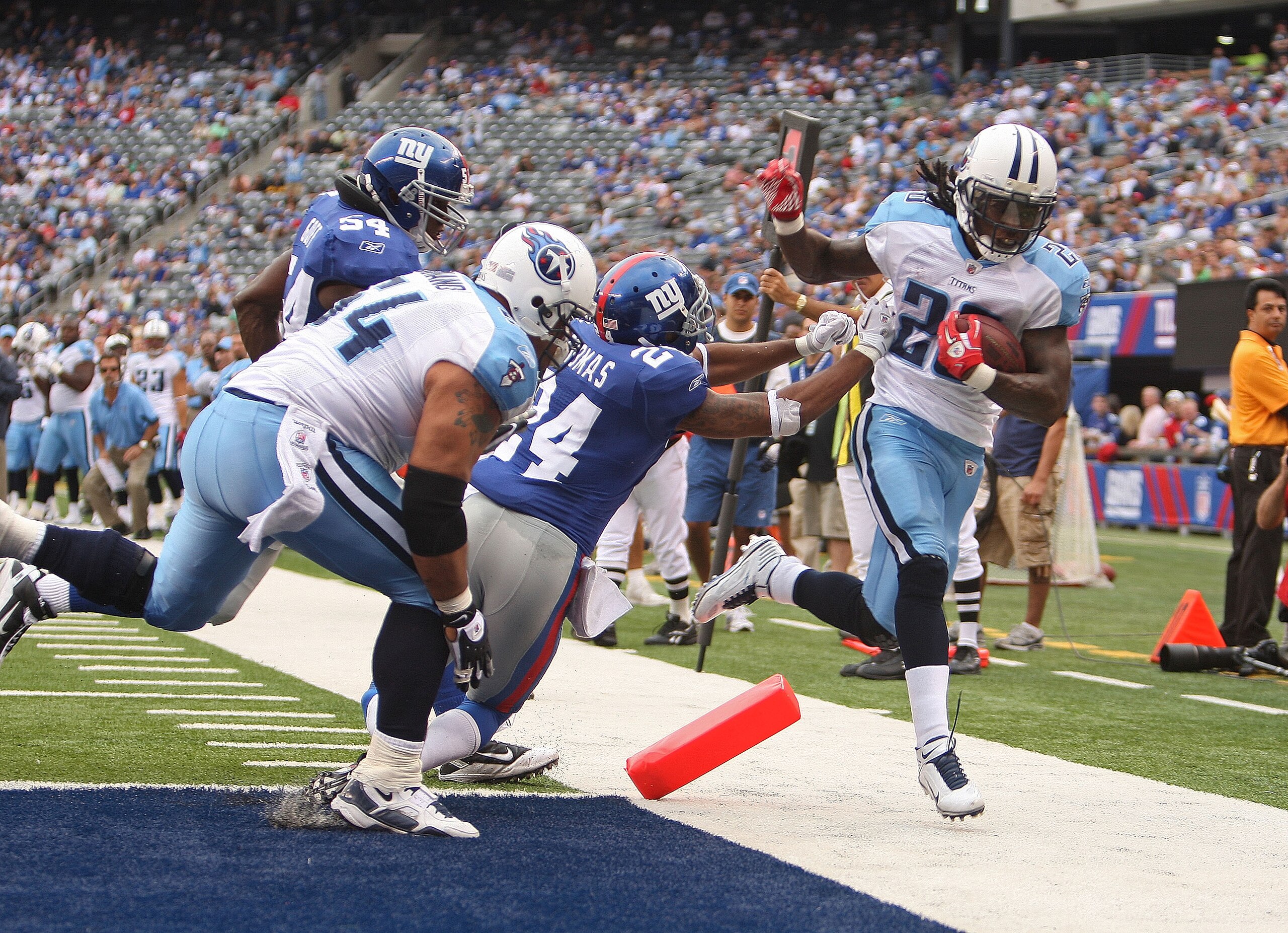 EAST RUTHERFORD, NJ - SEPTEMBER 26:  Chris Johnson #28 of the Tennessee Titans is pushed out of bounds at the endzone by Terrell Thomas #24 of the New York Giants at New Meadowlands Stadium on September 26, 2010 in East Rutherford, New Jersey.  (Photo by