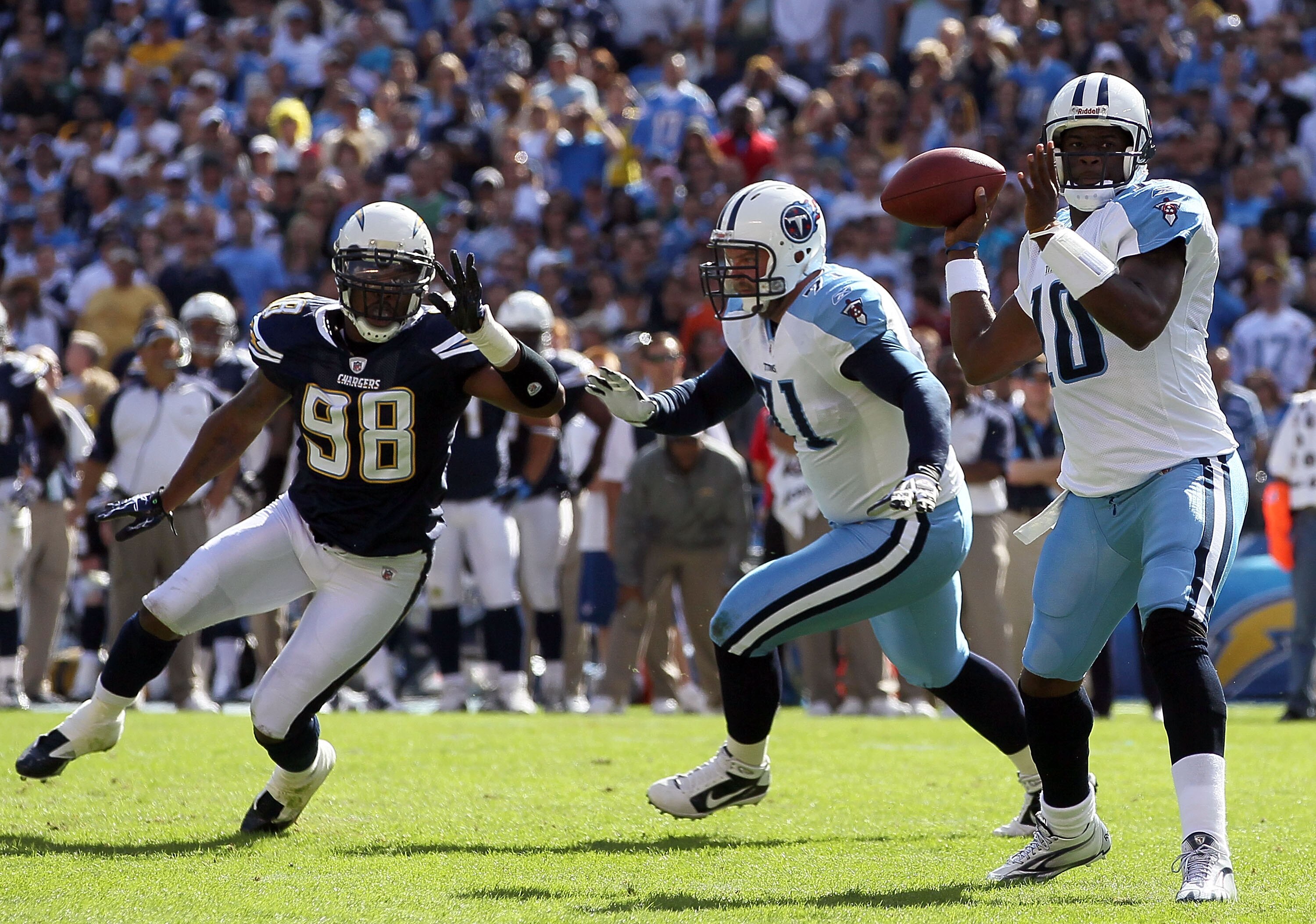 SAN DIEGO - OCTOBER 31:  Quarterback Vince Young #10 of the Tennessee Titans drops back to pass as Antwan Barnes #98 of the San Diego Chargers pressures during the game at Qualcomm Stadium on October 31, 2010 in San Diego, California. The Chargers defeate
