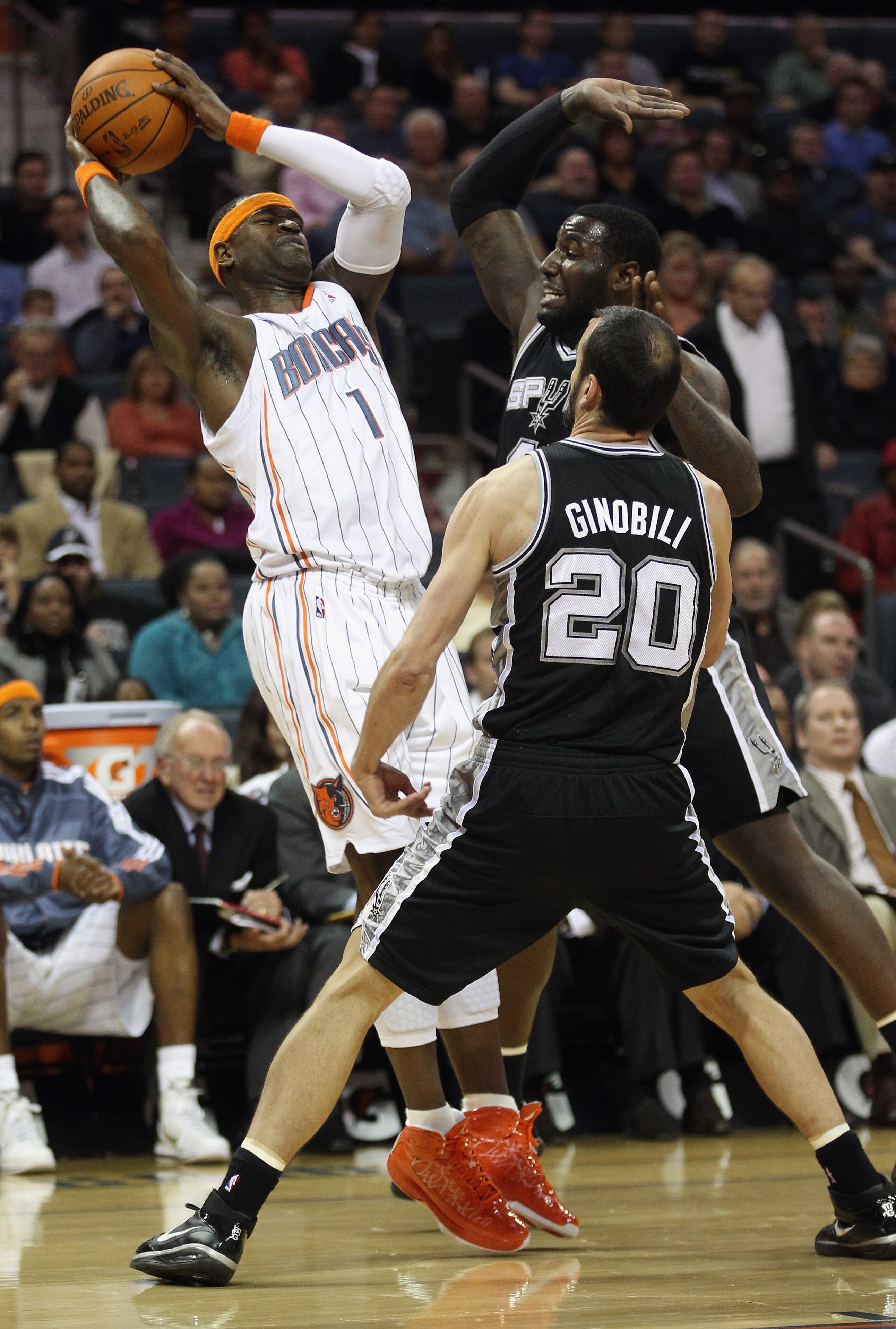 CHARLOTTE, NC - NOVEMBER 08:  Teammates Manu Ginobili #20 and DeJuan Blair #45 of the San Antonio Spurs try to trap Stephen Jackson #1 of the Charlotte Bobcats during their game at Time Warner Cable Arena on November 8, 2010 in Charlotte, North Carolina.