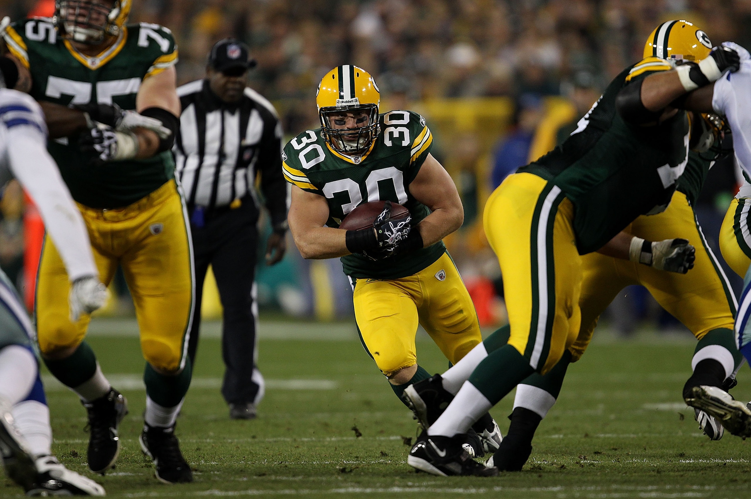 GREEN BAY, WI - NOVEMBER 07: John Kuhn #30 of the Green Bay Packers runs against the Dallas Cowboys at Lambeau Field on November 7, 2010 in Green Bay, Wisconsin. The Packers defeated the Cowboys 45-7. (Photo by Jonathan Daniel/Getty Images) GREEN BAY, WI - NOVEMBER 07: John Kuhn #30 of the Green Bay Packers runs against the Dallas Cowboys at Lambeau Field on November 7, 2010 in Green Bay, Wisconsin. The Packers defeated the Cowboys 45-7. (Photo by Jonathan Daniel/Getty Images)
