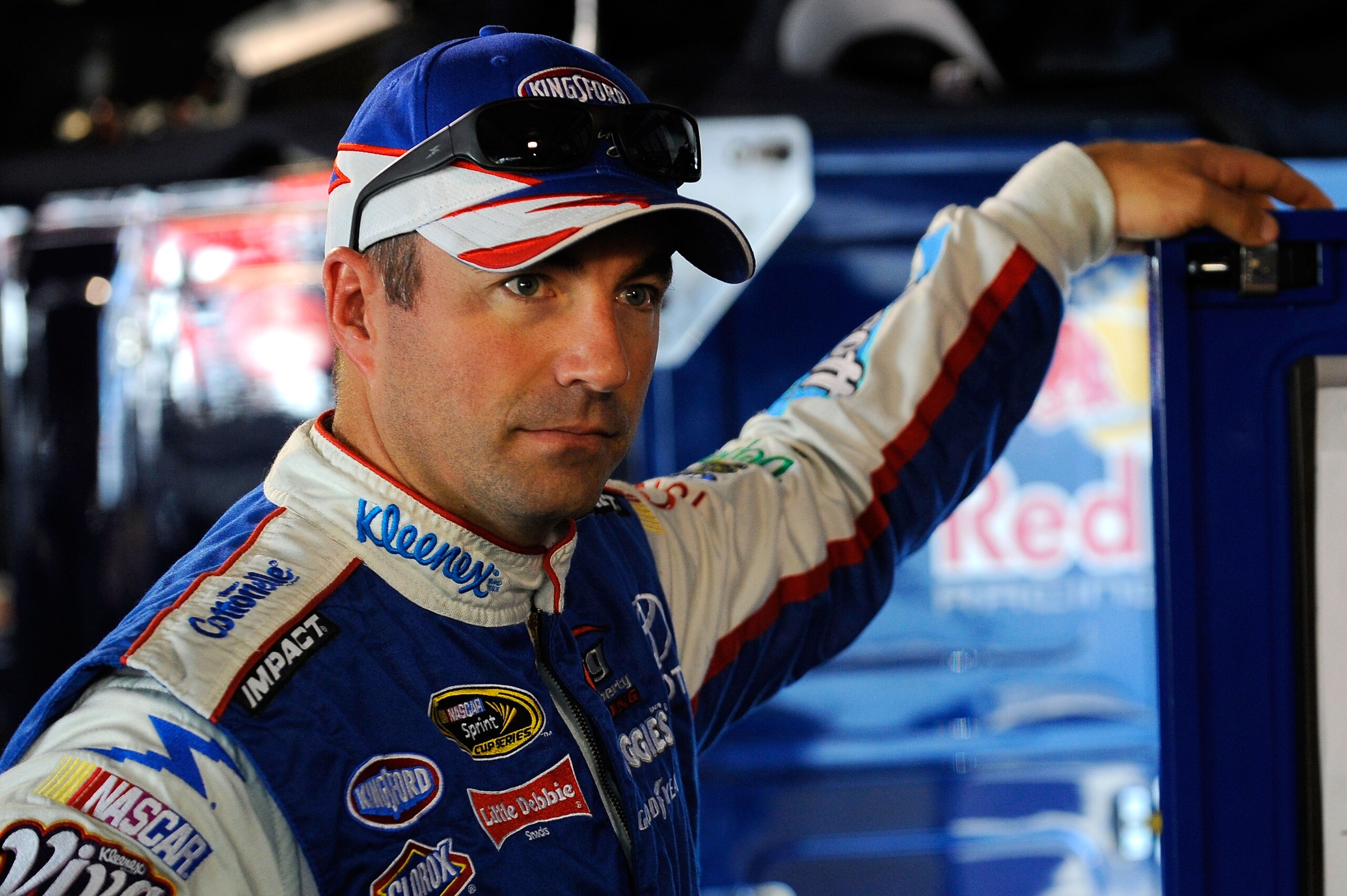 MARTINSVILLE, VA - OCTOBER 23:  Marcos Ambrose, driver of the #47 Dollar General Country Million Sweepstakes Toyota, stands in the garage during practice for the NASCAR Sprint Cup Series TUMS Fast Relief 500 at Martinsville Speedway on October 23, 2010 in
