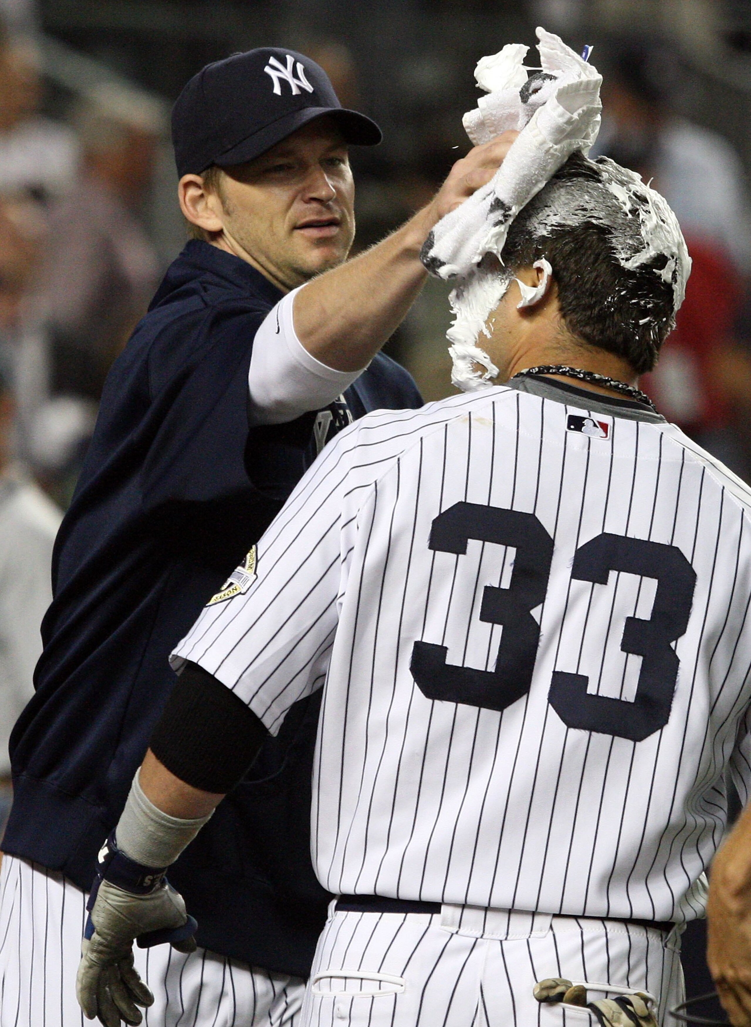 NEW YORK - SEPTEMBER 08:  Nick Swisher #33 of the New York Yankees receives a shaving cream pie from teammate A.J. Burnett #34 after his game winning walk off home run against the Tampa Bay Rays on September 8, 2009 at Yankee Stadium in the Bronx borough