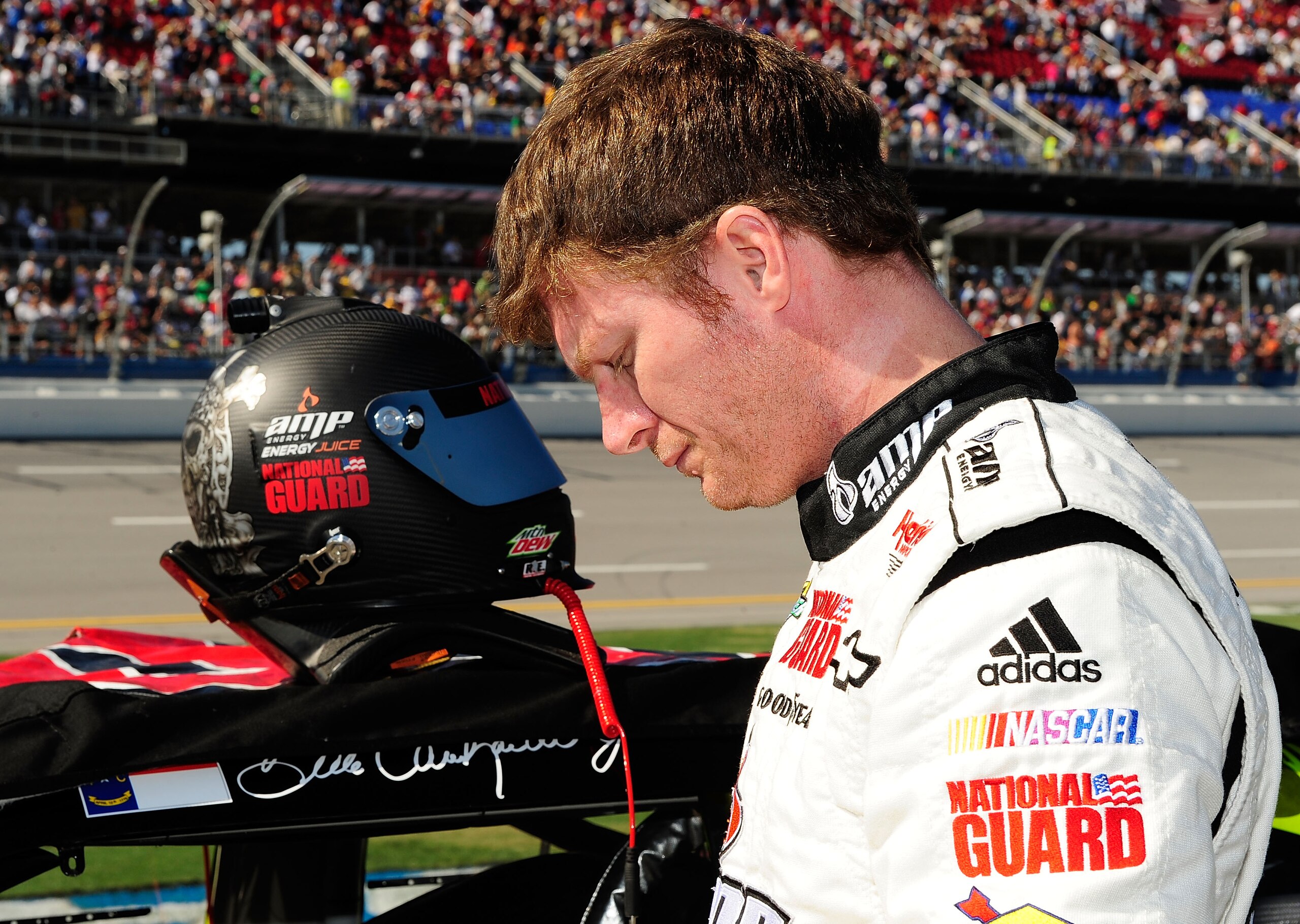 TALLADEGA, AL - OCTOBER 31:  Dale Earnhardt Jr., driver of the #88 LegendofHallowdega.com/AMP Energy Juice/National Guard Chevrolet, stands on the grid next to his car prior to the start of the NASCAR Sprint Cup Series AMP Energy Juice 500 at Talladega Su