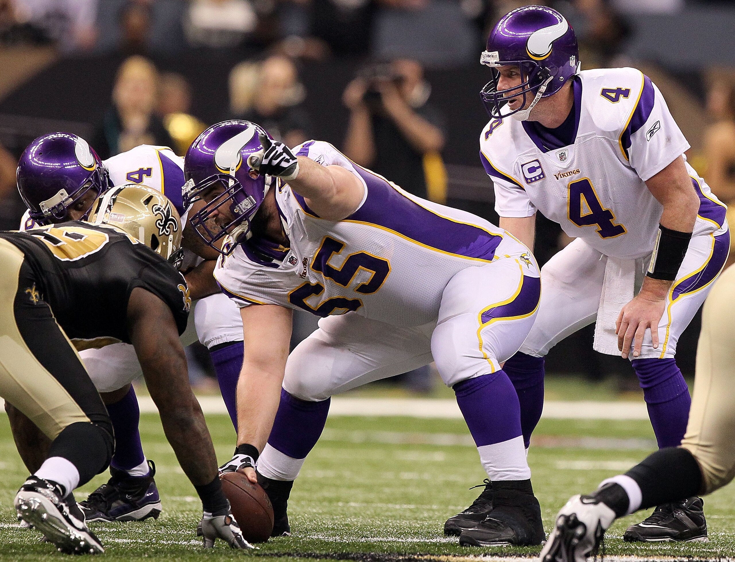 NEW ORLEANS - JANUARY 24:  Center John Sullivan #65 of the Minnesota Vikings gestures as Brett Favre calls the snap count at the line of scrimmage against the New Orleans Saints during the NFC Championship Game at the Louisiana Superdome on January 24, 20