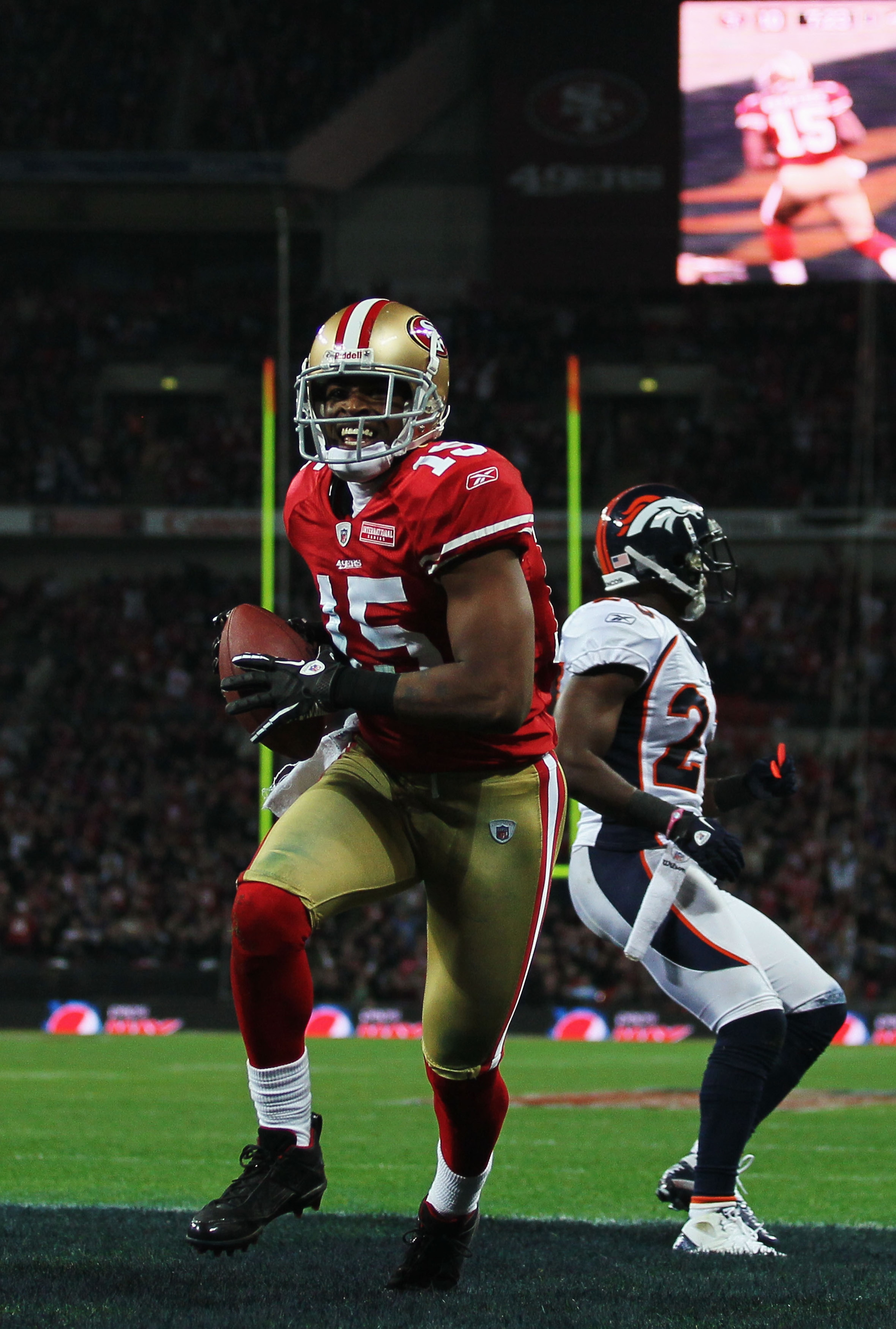 LONDON, ENGLAND - OCTOBER 31:  Michael Crabtree #15 of San Francisco 49ers beats Renaldo Hill #23 of Denver Broncos to score their second touchdown during the NFL International Series match between Denver Broncos and San Francisco 49ers at Wembley Stadium