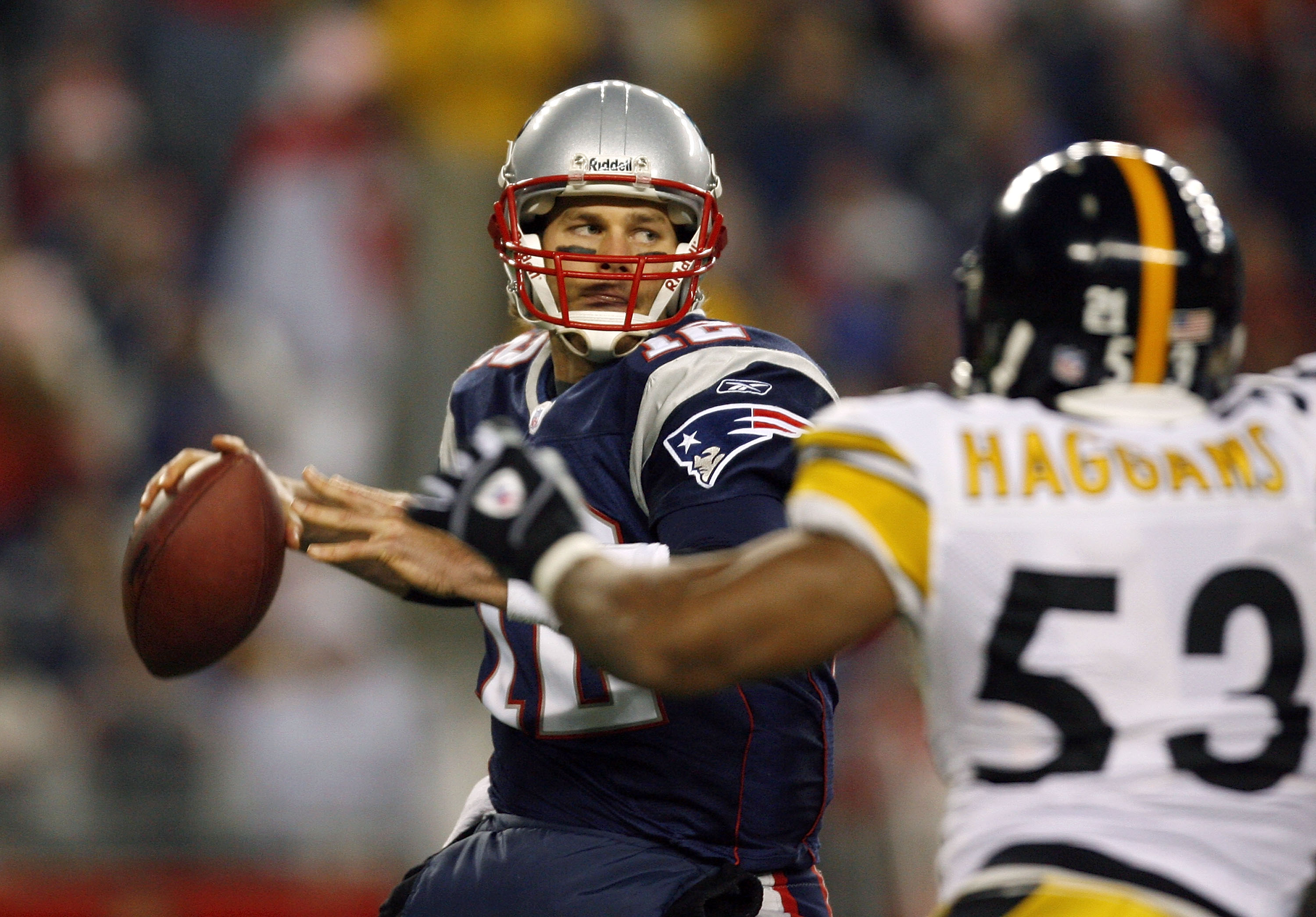 FOXBORO, MA - DECEMBER 9:  Tom Brady #12 of the New England Patriots looks for an open man under the pressure of Clark Haggans #53 of the Pittsburgh Steelers at Gillette Stadium December 9, 2007 in Foxboro, Massachusetts. (Photo by Jim Rogash/Getty Images