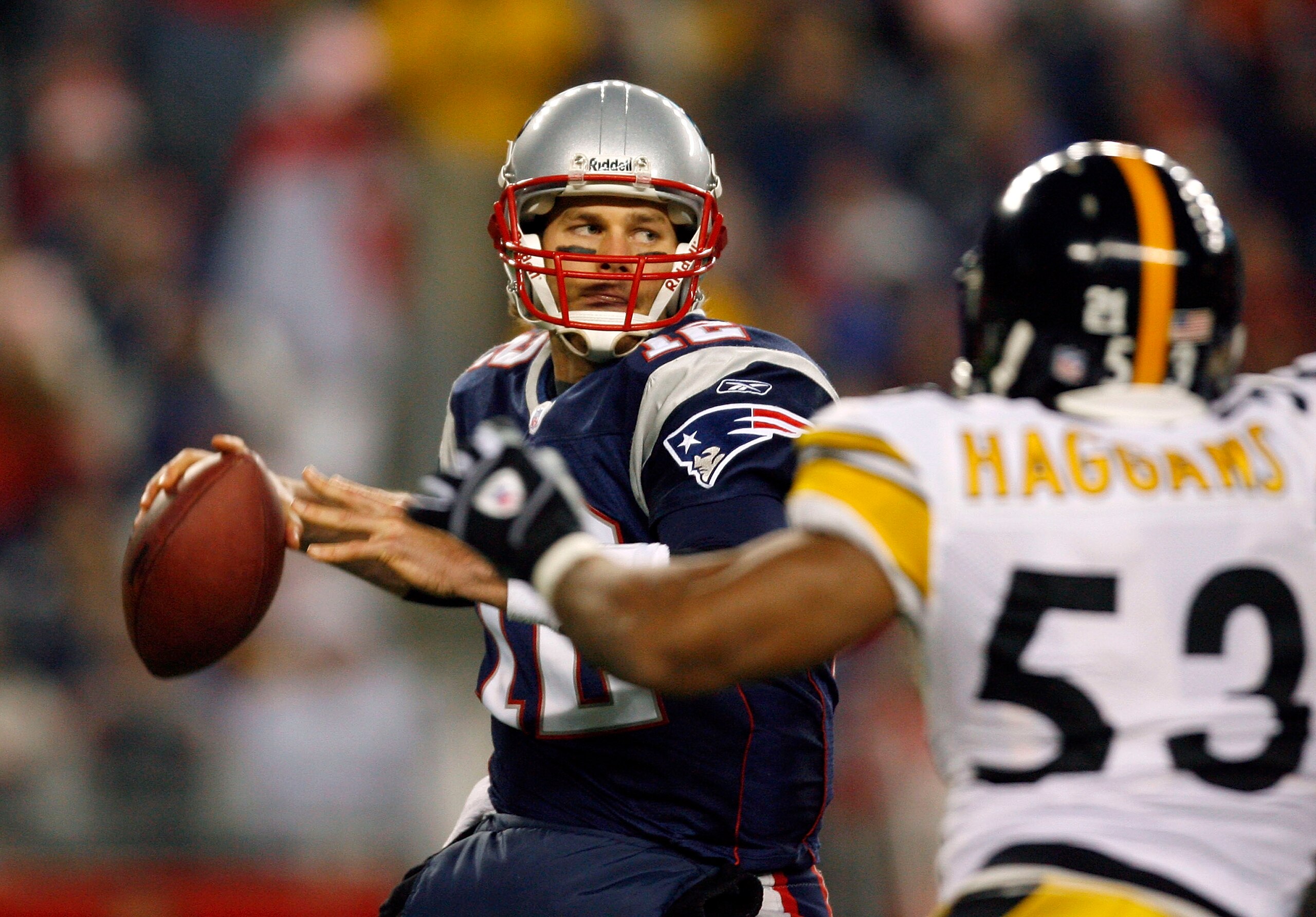 FOXBORO, MA - DECEMBER 9:  Tom Brady #12 of the New England Patriots looks for an open man under the pressure of Clark Haggans #53 of the Pittsburgh Steelers at Gillette Stadium December 9, 2007 in Foxboro, Massachusetts. (Photo by Jim Rogash/Getty Images