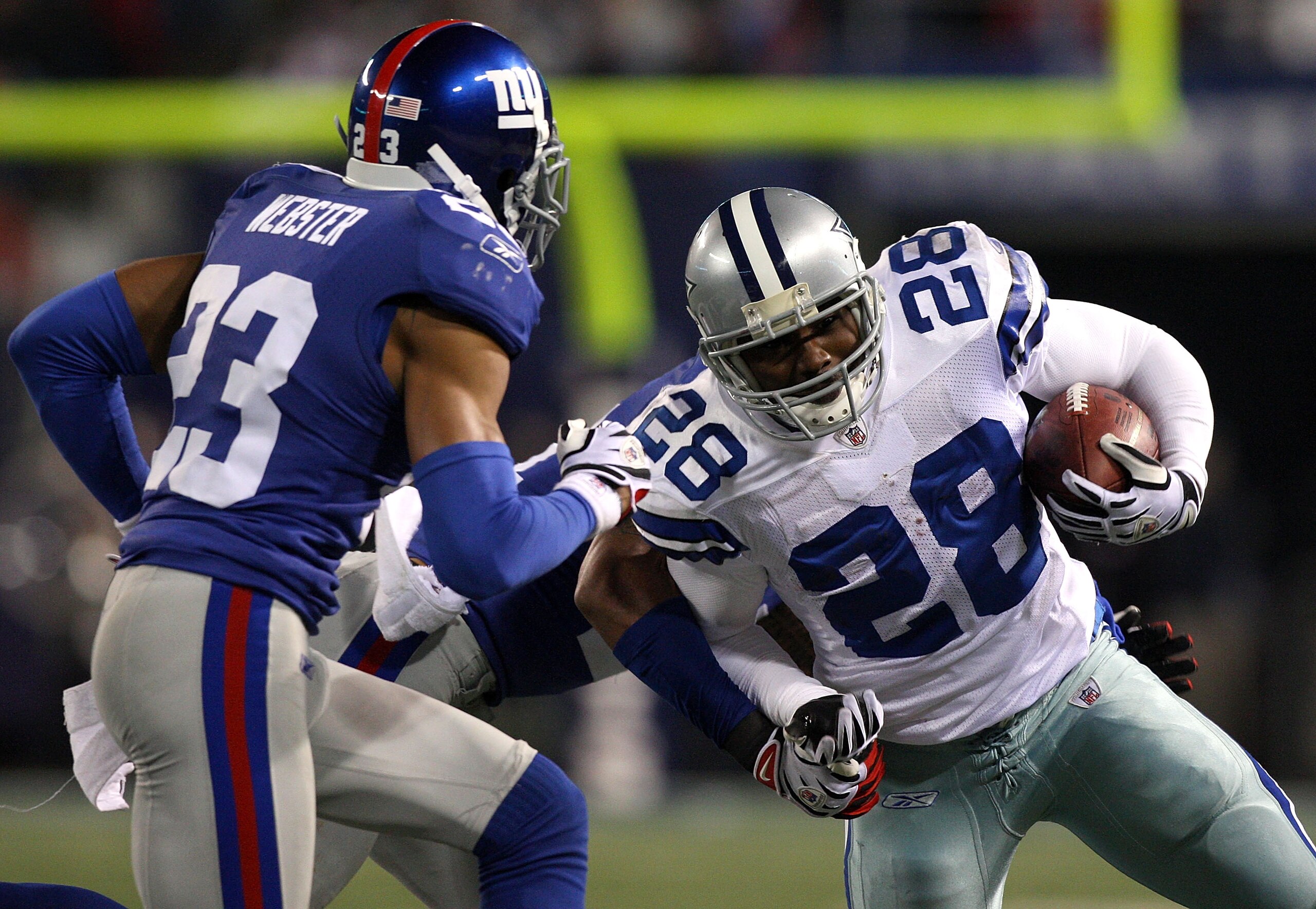 EAST RUTHERFORD, NJ - DECEMBER 06:  Felix Jones #28 of the Dallas Cowboys runs the ball against Corey Webster #23 of the New York Giants at Giants Stadium on December 6, 2009 in East Rutherford, New Jersey.  (Photo by Jim McIsaac/Getty Images)