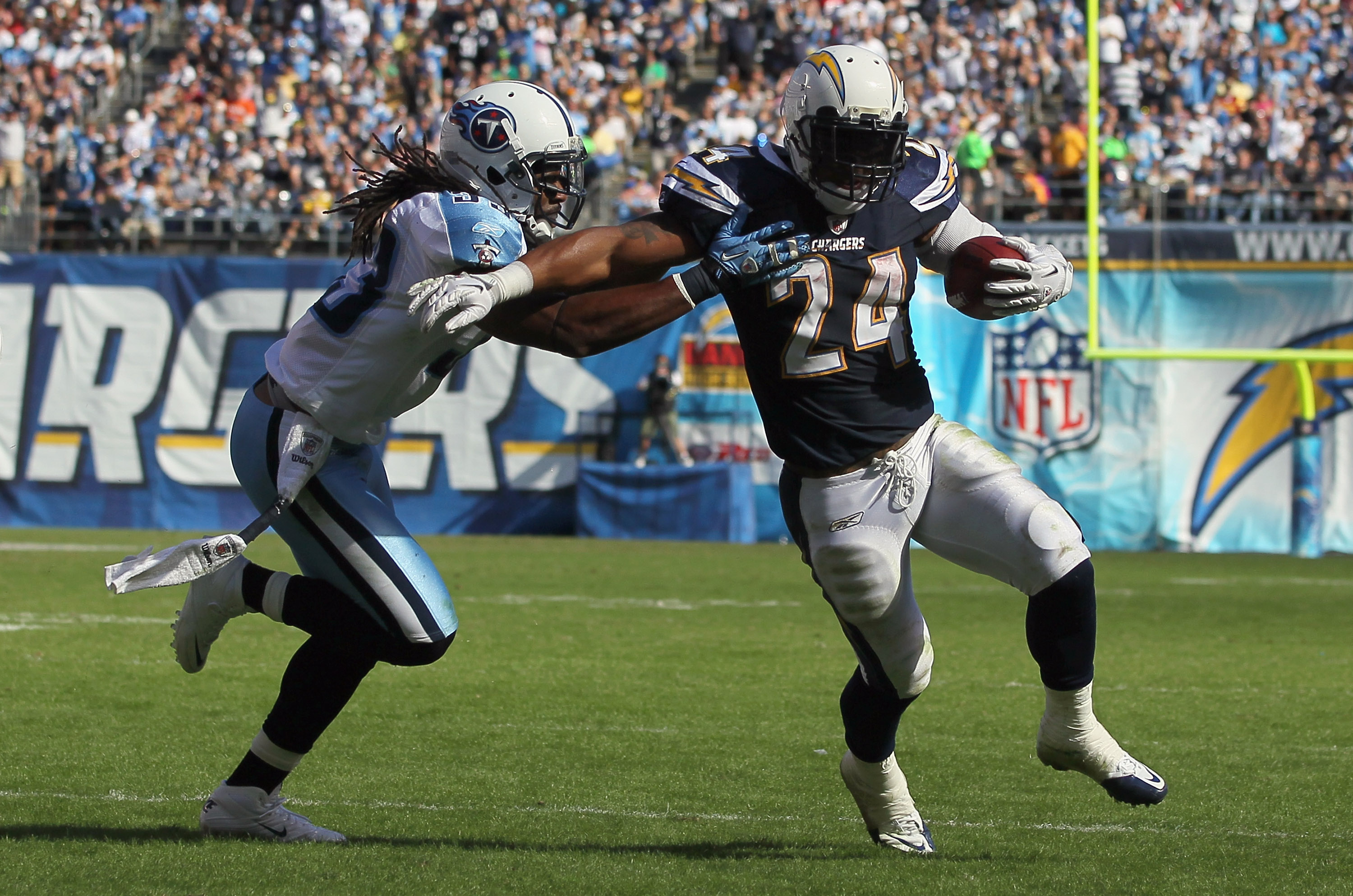 SAN DIEGO - OCTOBER 31:  Running back Ryan Mathews #24 of the San Diego Chargers is pursued by Michael Griffin #33 of the Tennessee Titans in the second quarter at Qualcomm Stadium on October 31, 2010 in San Diego, California. The Chargers defeated the Ti
