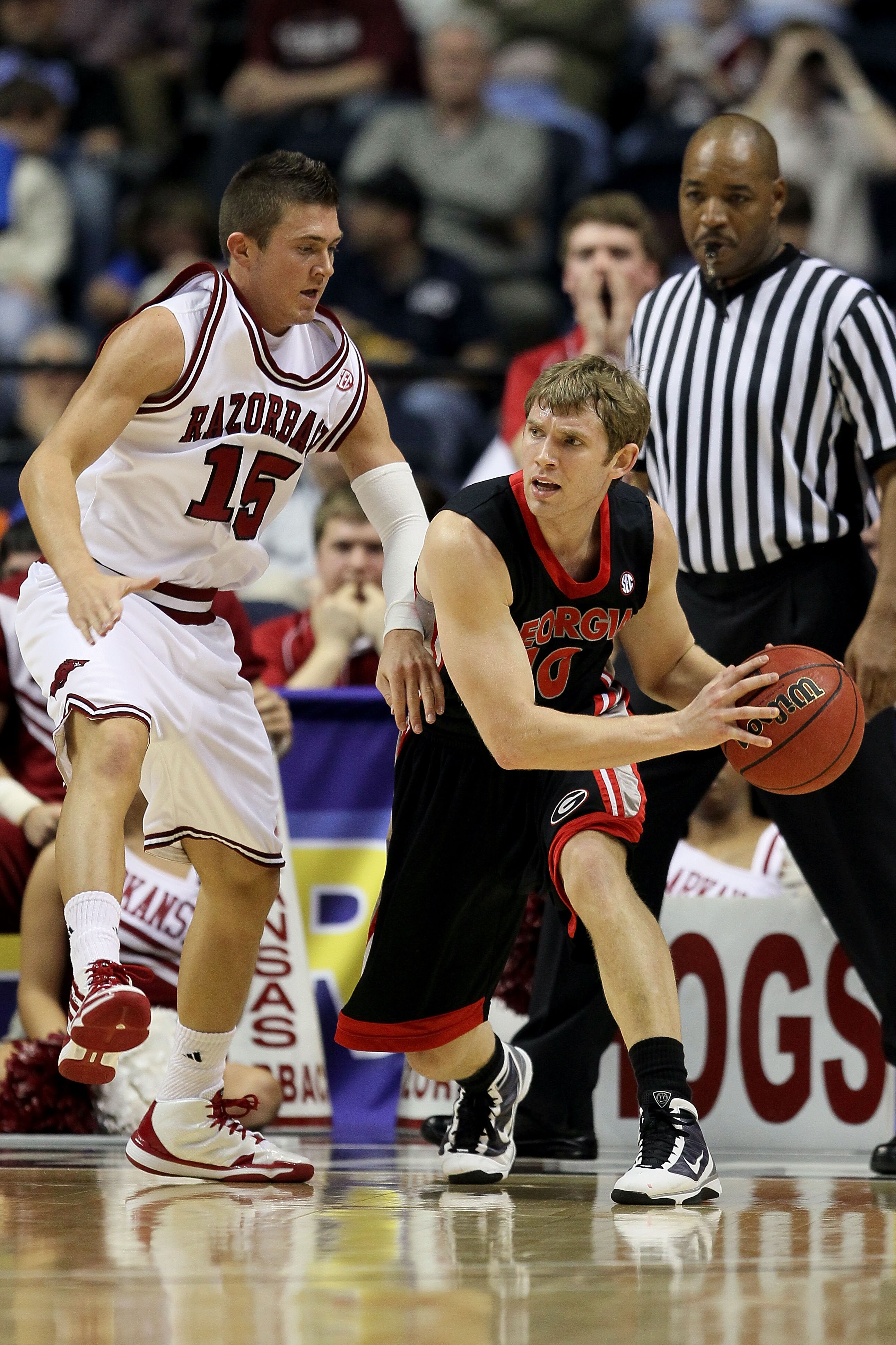 NASHVILLE, TN - MARCH 11:  Ricky McPhee #10 of the Georgia Bulldogs looks to pass against Rotnei Clarke #15 of the Arkanasas Razorbacks during the first round of the SEC Men's Basketball Tournament at the Bridgestone Arena on March 11, 2010 in Nashville,