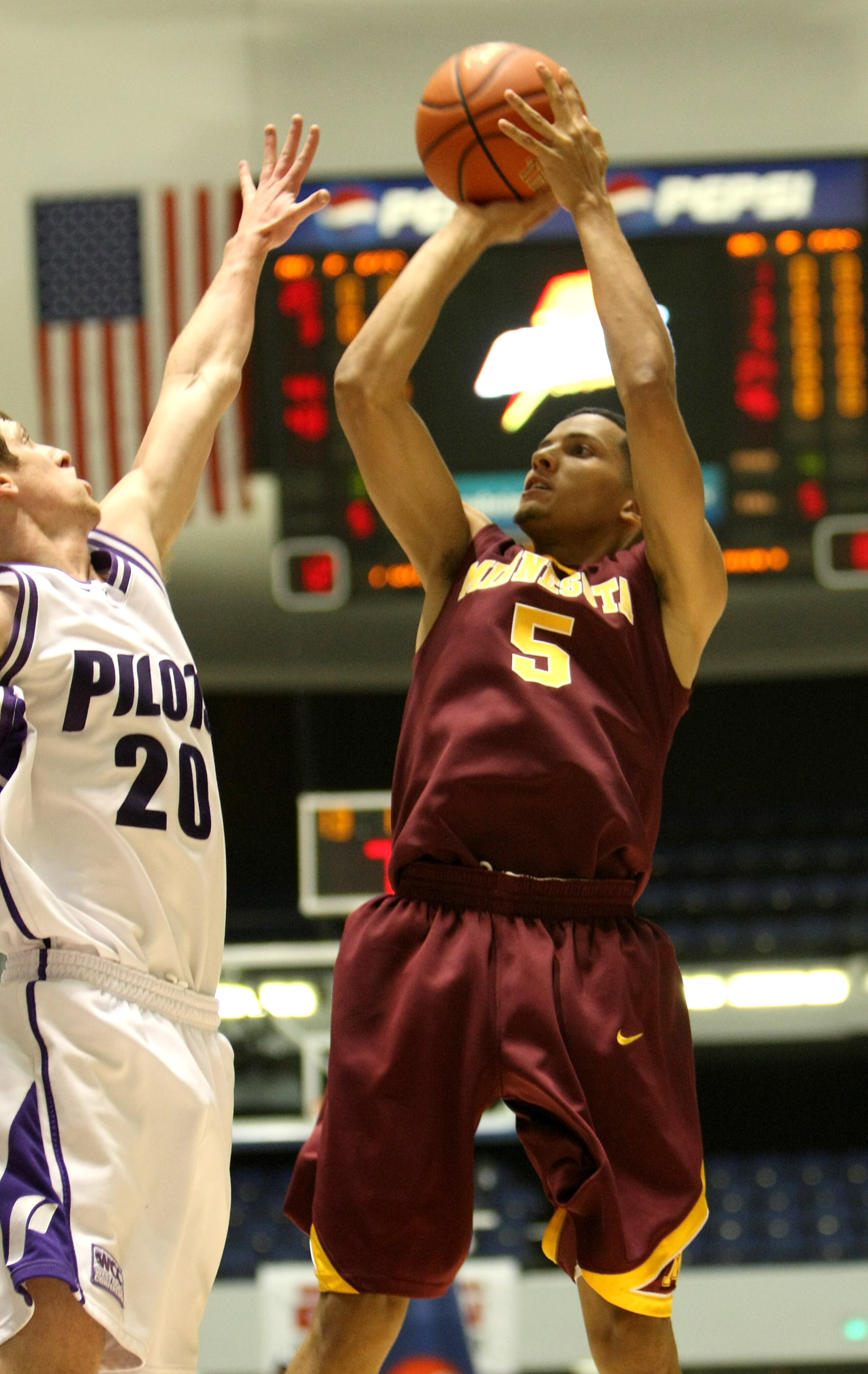 ANAHEIM, CA - NOVEMBER 27:  Devoe Joseph #5 of the Minnesota Gophers shoot over Jared Stohl #20 of the Portland Pilots at the 76 Classic at Anaheim Convention Center on November 27, 2009 in Anaheim, California.  (Photo by Stephen Dunn/Getty Images)