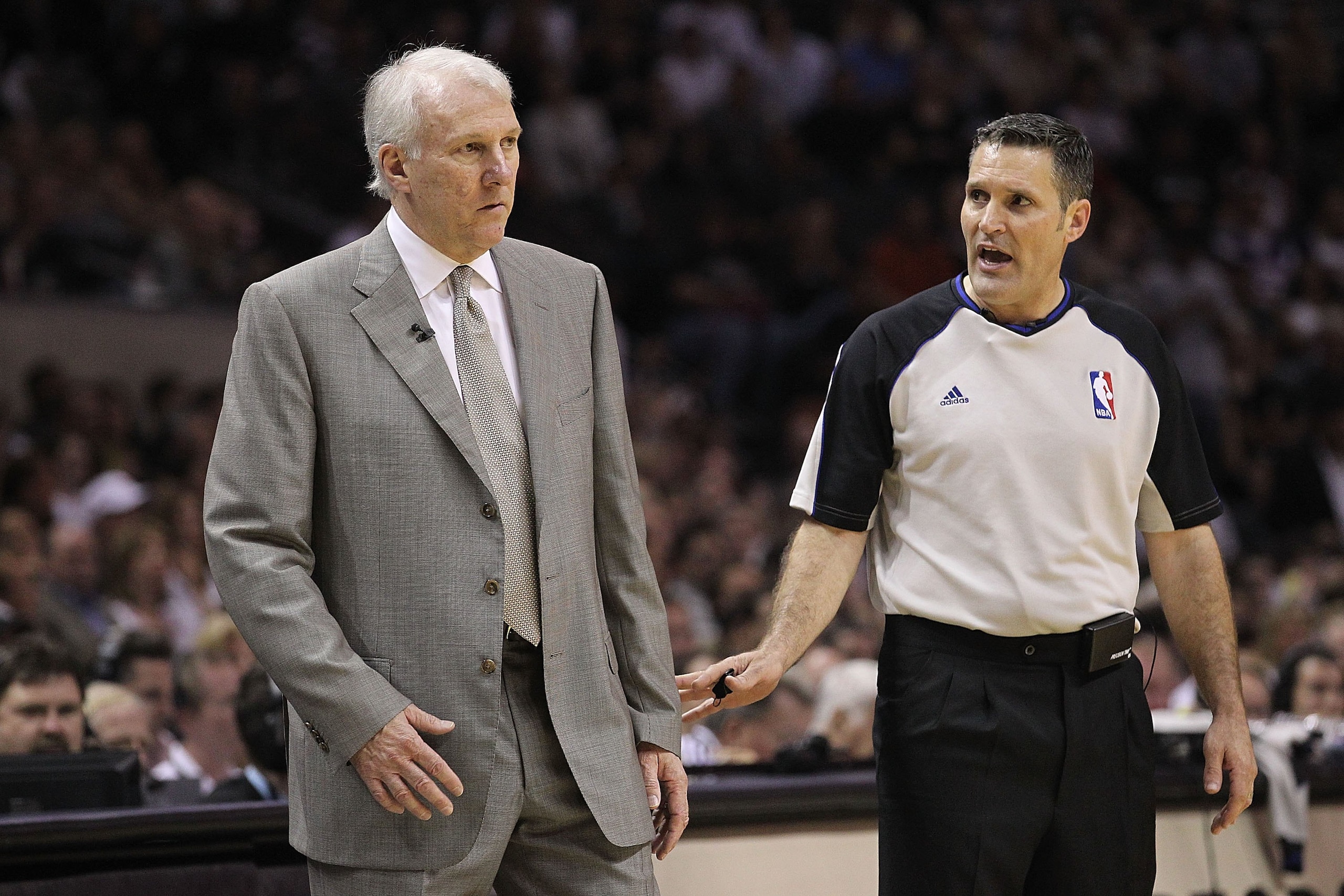 SAN ANTONIO - MAY 09:  Head coach Gregg Popovich of the San Antonio Spurs and referee, Monty McCutchen in Game Four of the Western Conference Semifinals during the 2010 NBA Playoffs at AT&T Center on May 9, 2010 in San Antonio, Texas. NOTE TO USER: User e