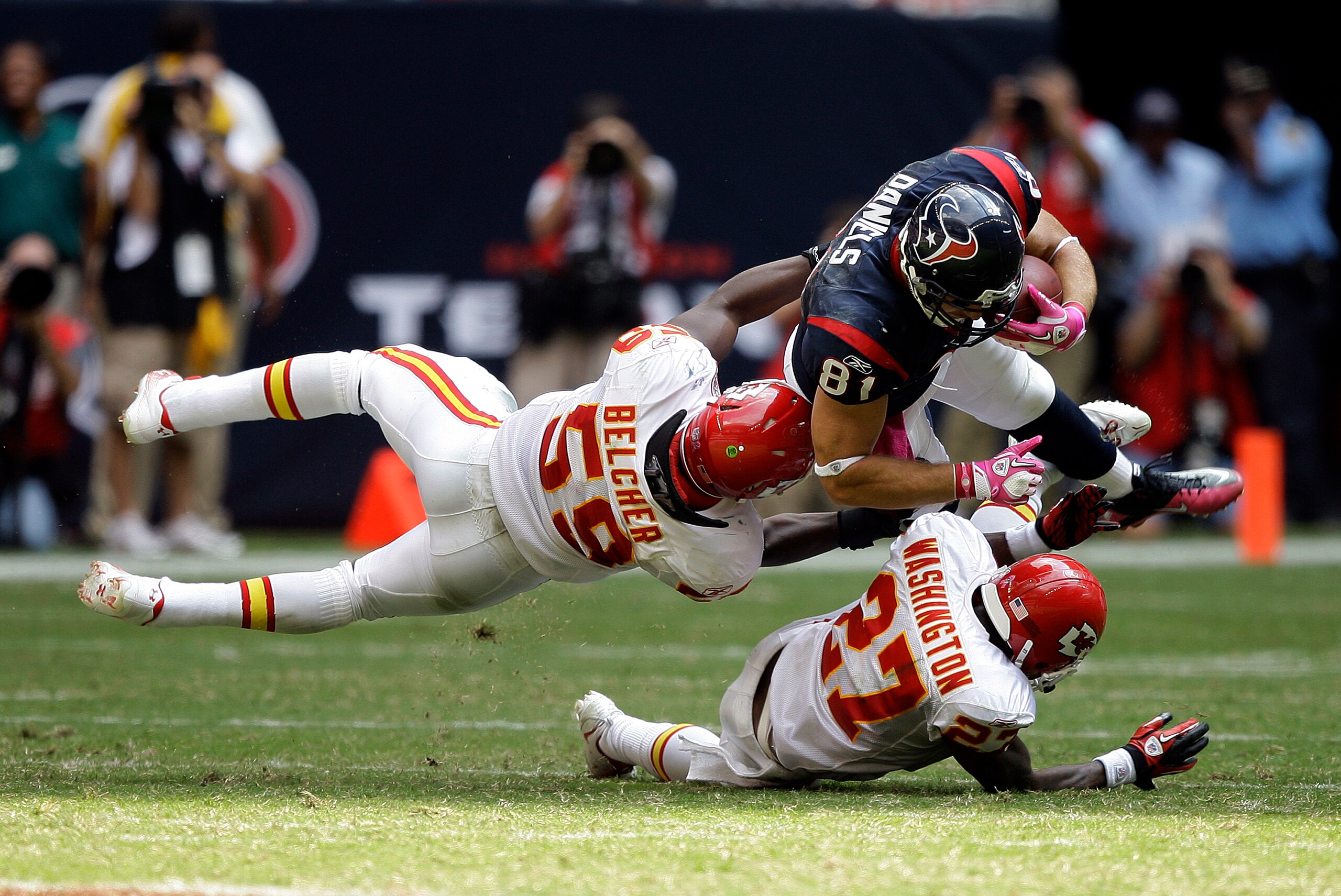 HOUSTON - OCTOBER 17:  Owen Daniels #81 of the Houston Texans is tackled by linebacker Jovan Belcher #59 and cornerback Donald Washington #27 of the Kansas City Chiefs at Reliant Stadium on October 17, 2010 in Houston, Texas.  (Photo by Bob Levey/Getty Im