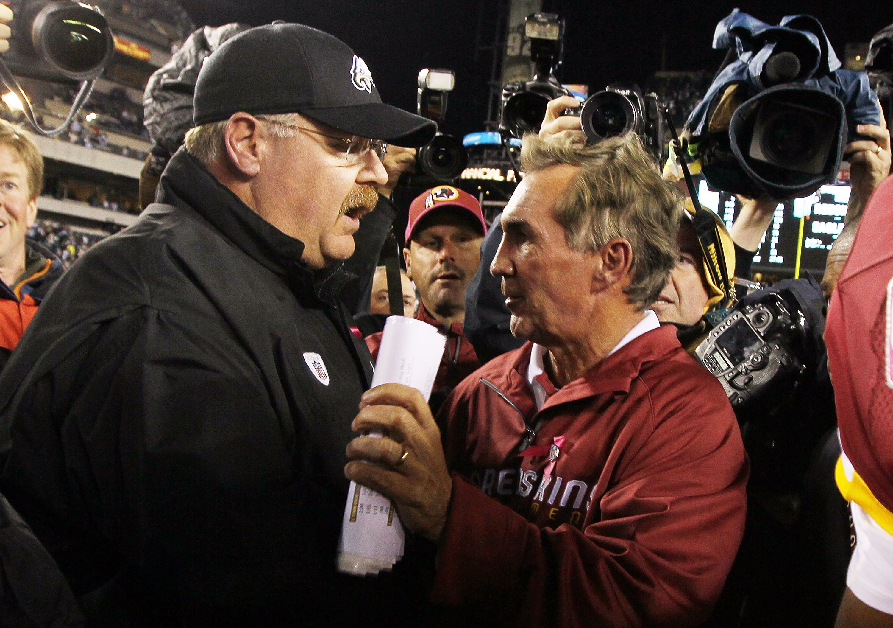 PHILADELPHIA - OCTOBER 03:  Head coach Andy Reid of the Philadelphia Eagles meets with head coach Mike Shanahan of the Washington Redskins after their game on October 3, 2010 at Lincoln Financial Field in Philadelphia, Pennsylvania. The Redskins defeated
