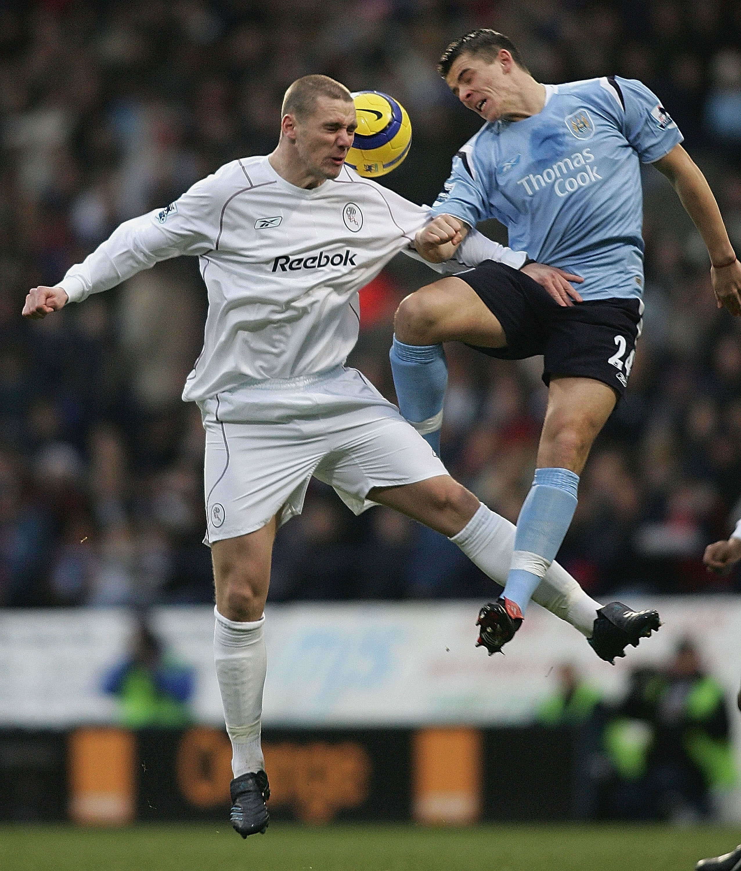 BOLTON, ENGLAND - DECEMBER 18:  Kevin Nolan (L) of Bolton challenges Joey Barton of Manchester City during the Barclays Premiership match between Bolton Wanderers and Manchester City at the Reebok Stadium on December 18, 2004 in Bolton, England.  (Photo b