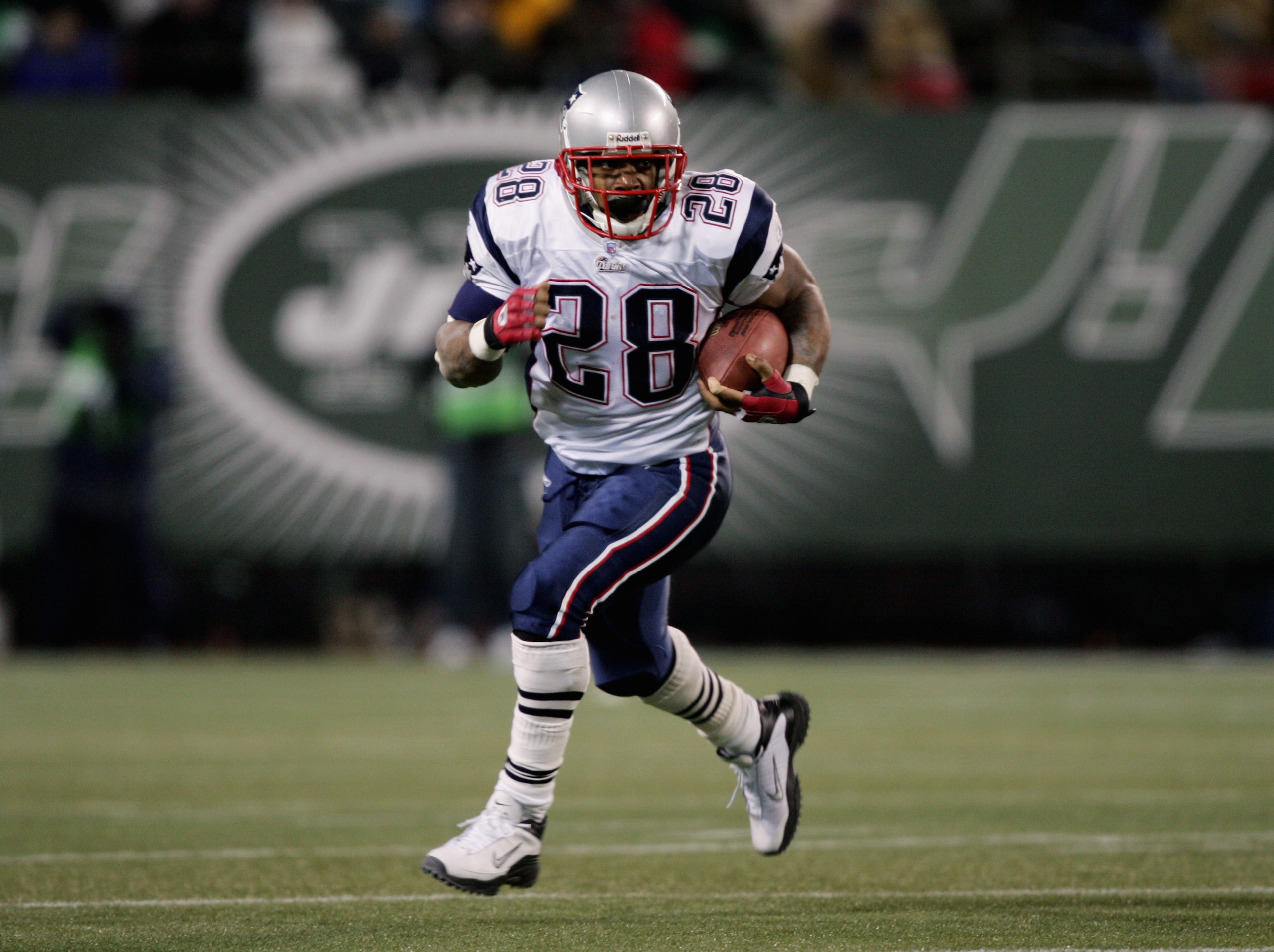 EAST RUTHERFORD, NJ - DECEMBER 26:  Corey Dillon #28 of the New England Patriots carries the ball against the New York Jets on December 26, 2004 at Giants Stadium in East Rutherford, New Jersey.  The Patriots won the game 23-7.  (Photo by Al Bello/Getty I