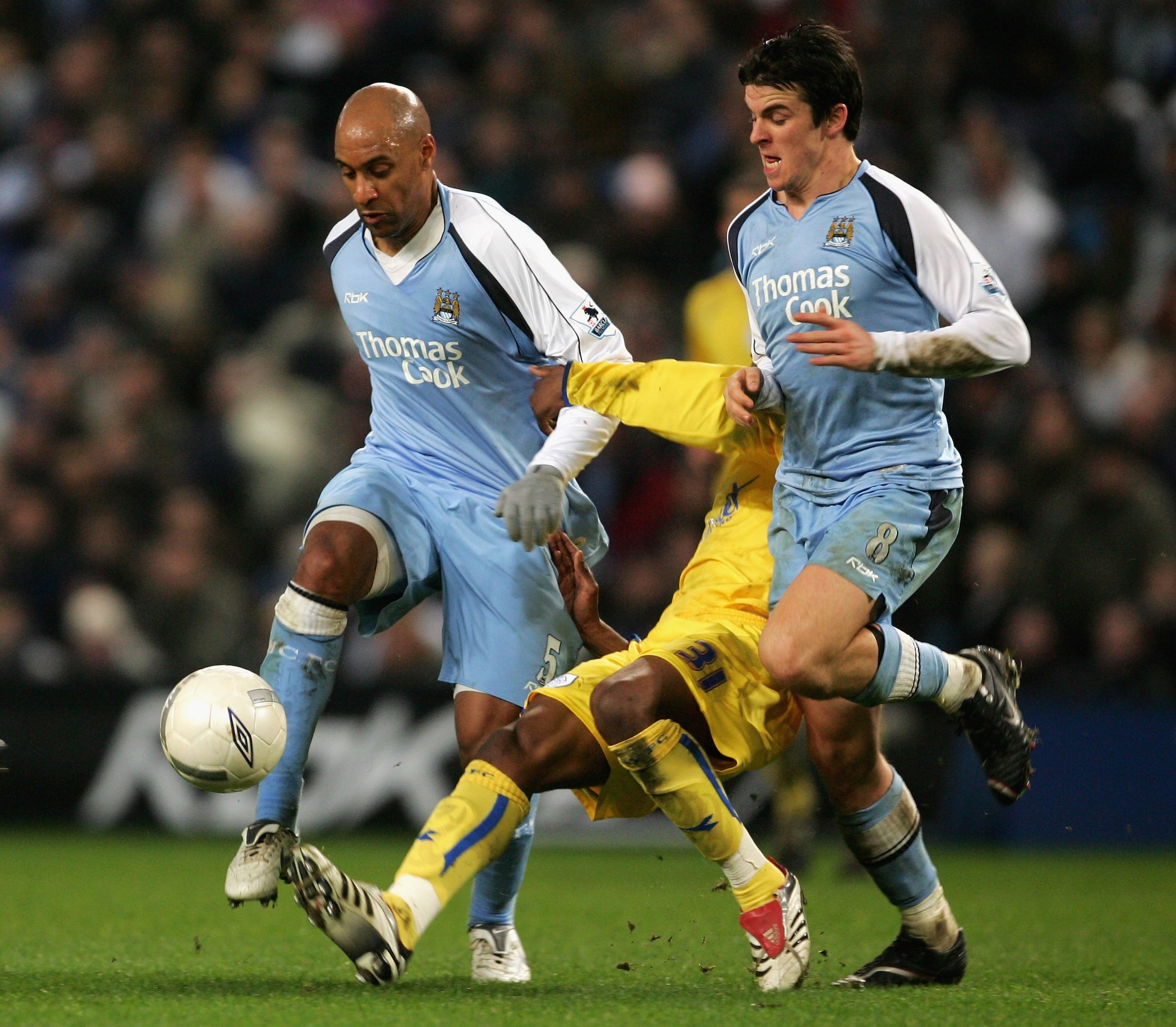 MANCHESTER, UNITED KINGDOM - JANUARY 16:  Ousmane Dabo and Joey Barton of Manchester City clash with Yoanne Folly of Sheffield Wednesday during the FA Cup sponsored by E.ON Third Round replay match between Manchester City and  Sheffield Wednesday at the C