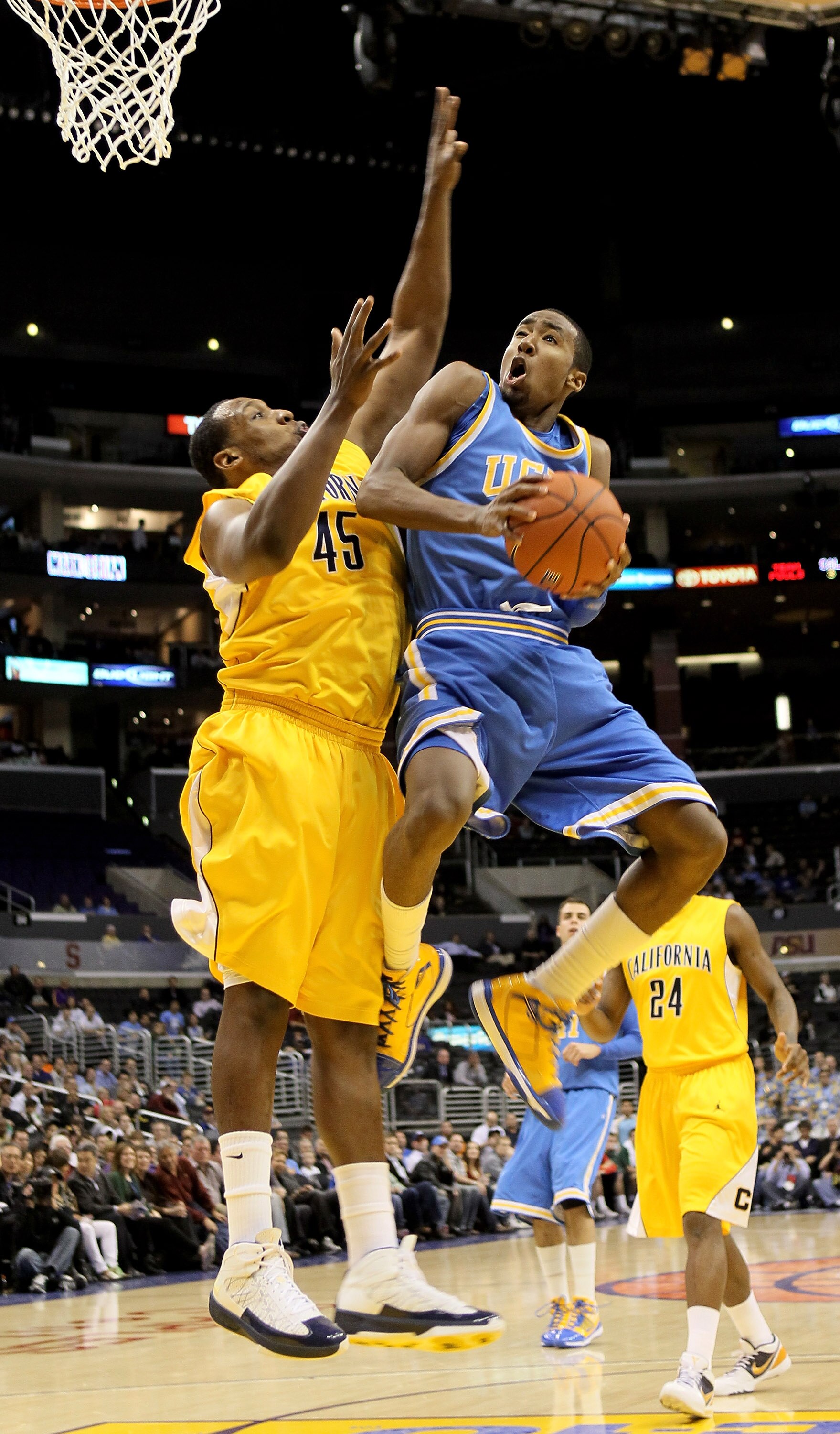 LOS ANGELES, CA - MARCH 12:  Malcolm Lee #3 of the UCLA Bruins is fouled as he goes up for a shot against Markhuri Sanders-Frison #45 of the California Golden Bears during the semifinals of the Pac-10 Basketball Tournament at Staples Center on March 12, 2