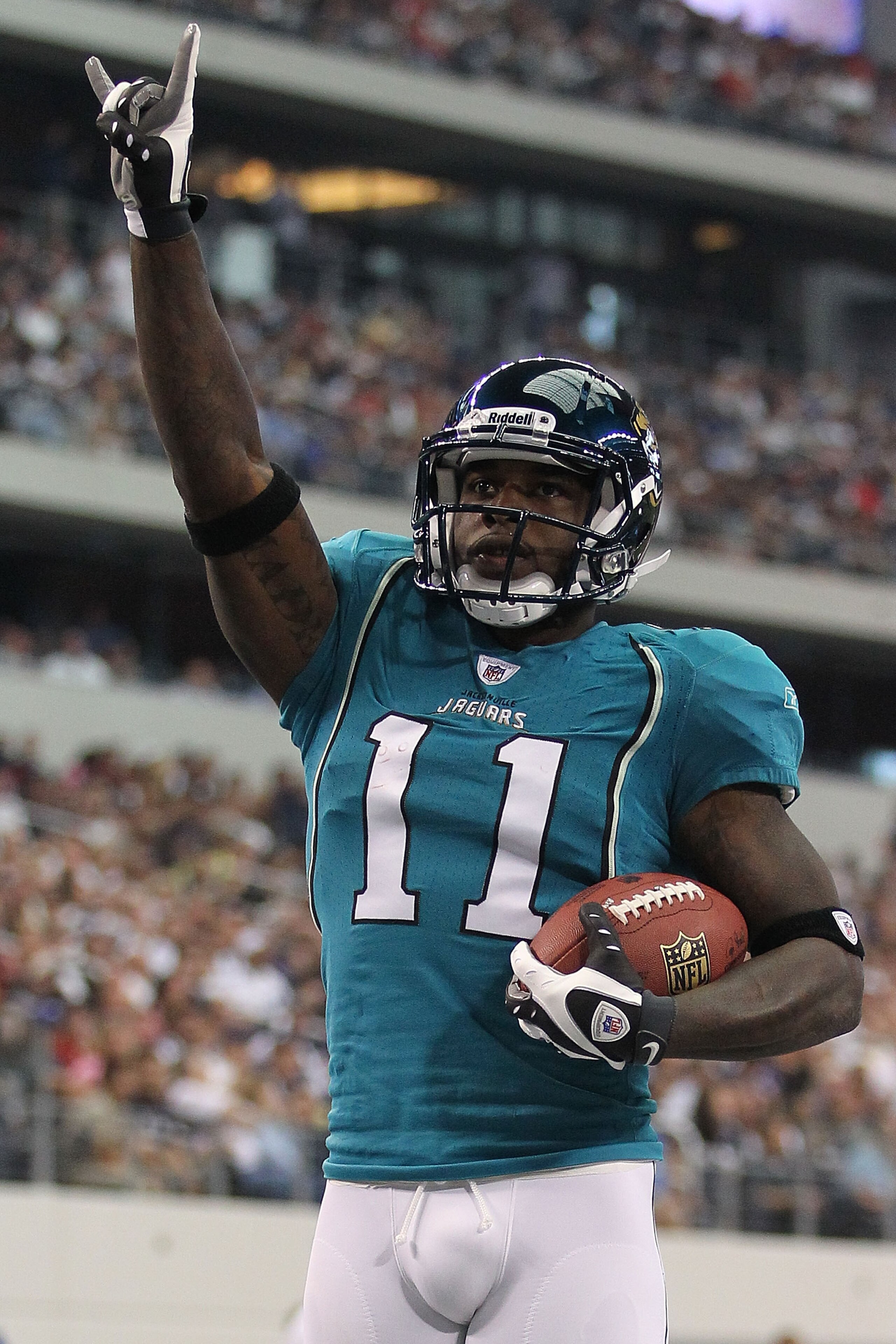 ARLINGTON, TX - OCTOBER 31:  Wide receiver Mike Sims-Walker #11 of the Jacksonville Jaguars celebrates a touchdown against the Dallas Cowboys in the first quarter at Cowboys Stadium on October 31, 2010 in Arlington, Texas.  (Photo by Ronald Martinez/Getty