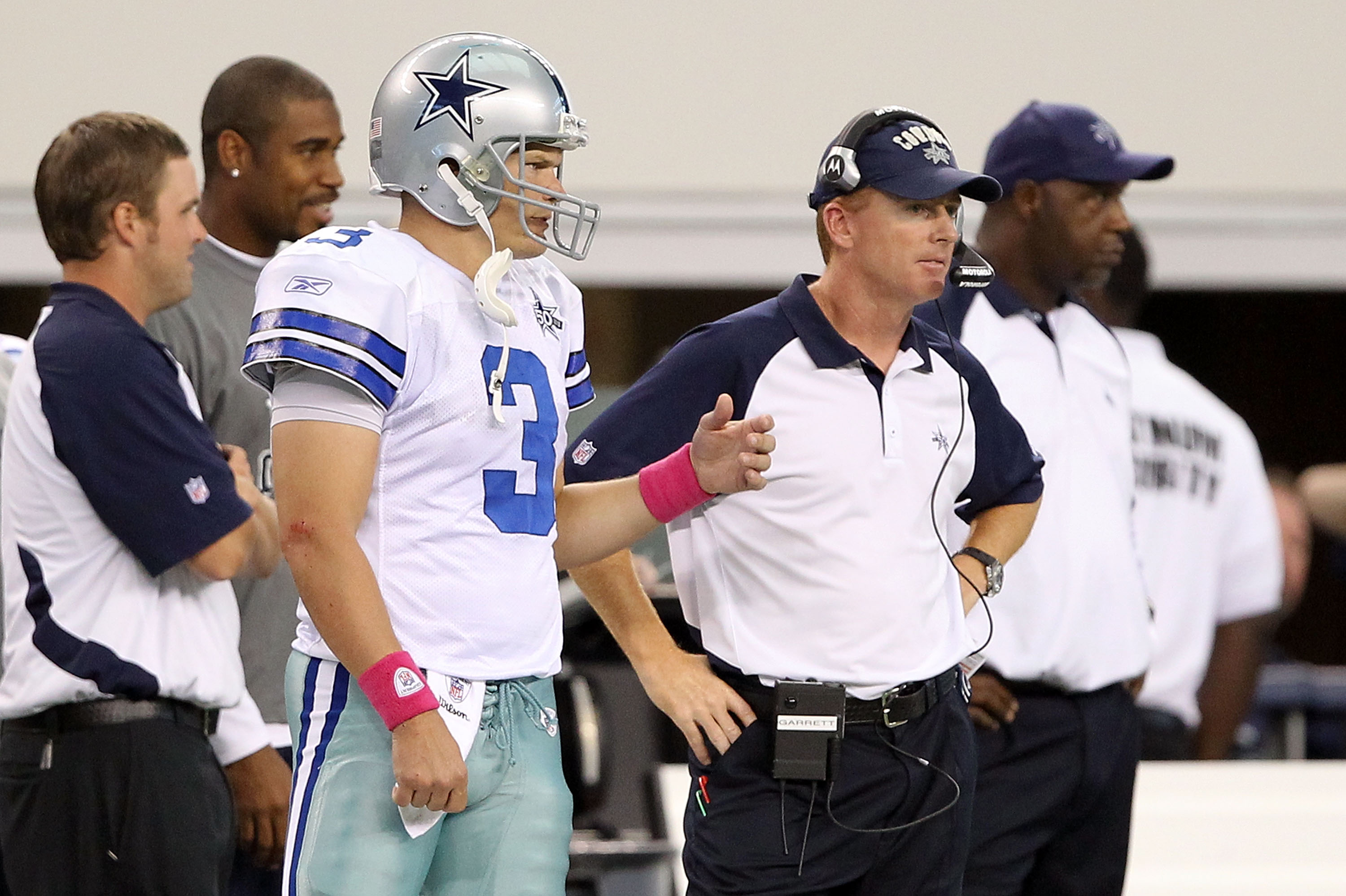ARLINGTON, TX - OCTOBER 31:  (L-R) Quarterback Jon Kitna and assistant head coahc/offensive coordinator Jason Garrett of the Dallas Cowboys look on from the sideline against the Jacksonville Jaguars at Cowboys Stadium on October 31, 2010 in Arlington, Tex