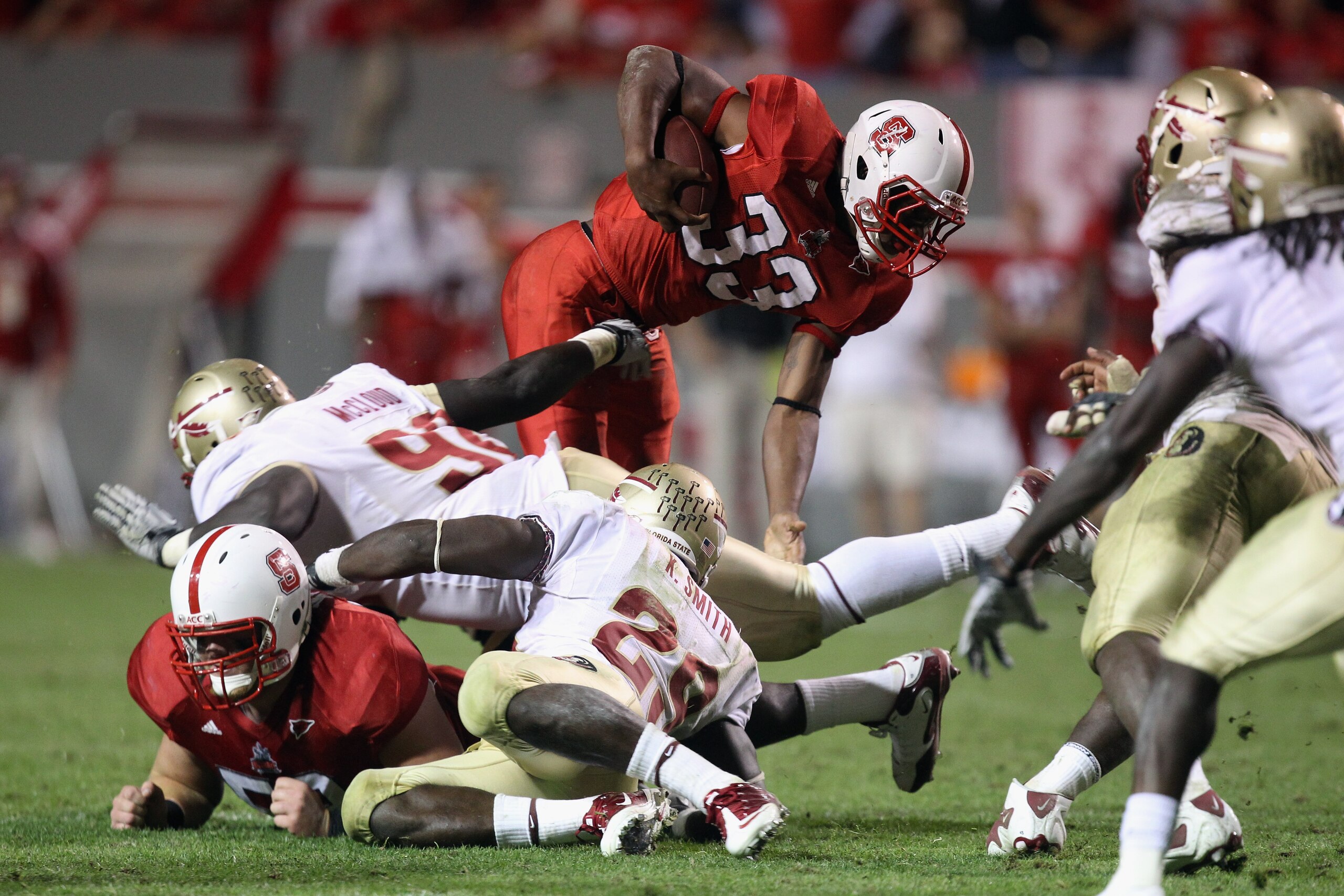 RALEIGH, NC - OCTOBER 28:  Mustafa Greene #33 of the North Carolina State Wolfpack runs with the ball against the Florida State Seminoles during their game at Carter-Finley Stadium on October 28, 2010 in Raleigh, North Carolina.  (Photo by Streeter Lecka/