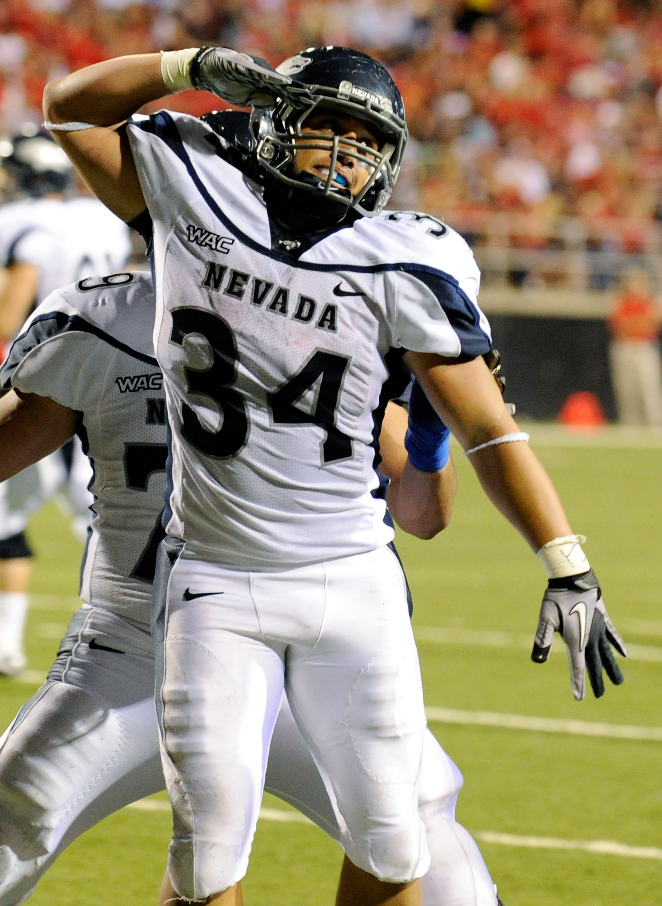 LAS VEGAS - OCTOBER 02:  Vai Taua #34 of the Nevada Reno Wolf Pack celebrates after scoring a touchdown against the UNLV Rebels in the second quarter of their game at Sam Boyd Stadium October 2, 2010 in Las Vegas, Nevada. Nevada Reno won 44-26.  (Photo by