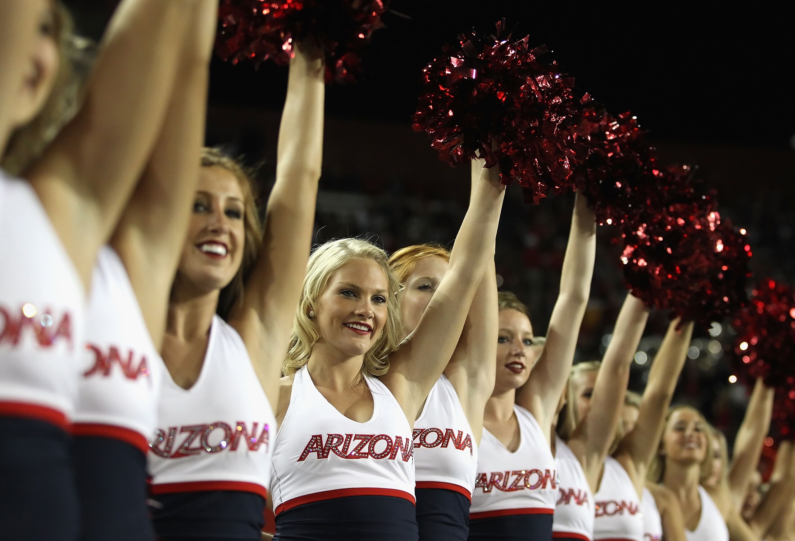TUCSON, AZ - OCTOBER 23:  Arizona Wildcats cheerleaders peform during the college football game against the Washington Huskies at Arizona Stadium on October 23, 2010 in Tucson, Arizona.   The Wildcats defeated the Huskies 44-14.  (Photo by Christian Peter