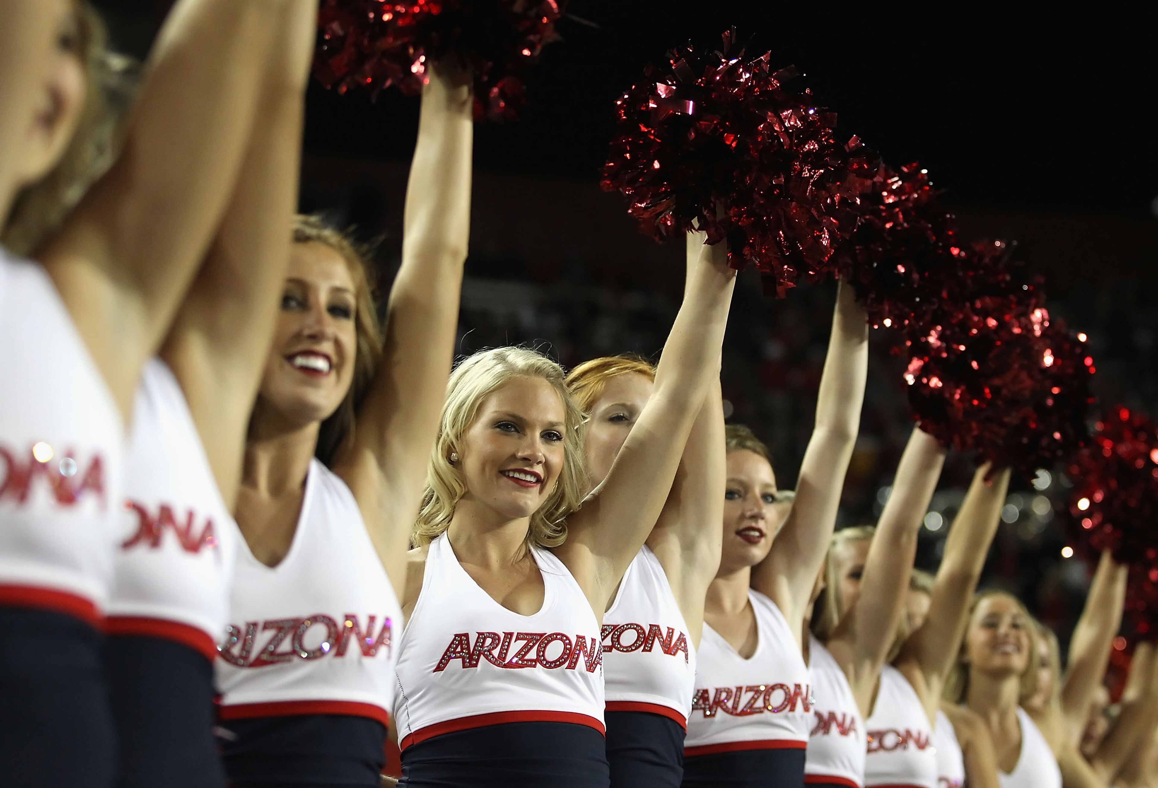 TUCSON, AZ - OCTOBER 23: Arizona Wildcats cheerleaders peform during the college football game against the Washington Huskies at Arizona Stadium on October 23, 2010 in Tucson, Arizona. The Wildcats defeated the Huskies 44-14. (Photo by Christian Peter TUCSON, AZ - OCTOBER 23: Arizona Wildcats cheerleaders peform during the college football game against the Washington Huskies at Arizona Stadium on October 23, 2010 in Tucson, Arizona. The Wildcats defeated the Huskies 44-14. (Photo by Christian Peter