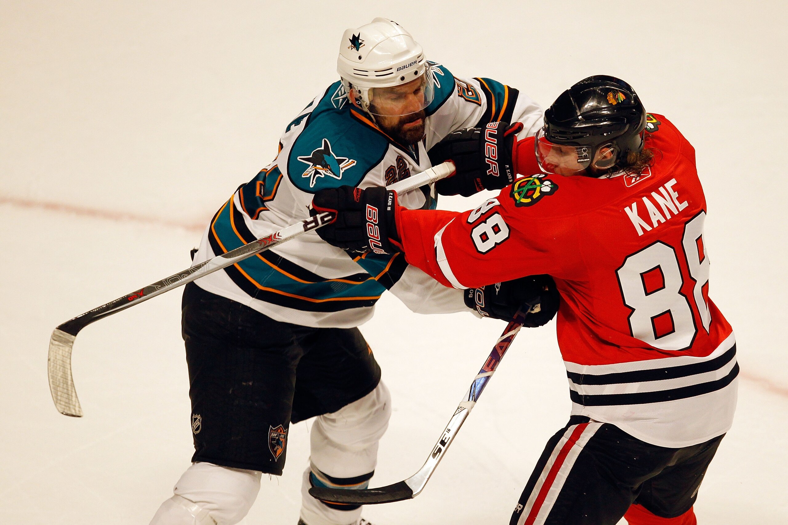 CHICAGO - MAY 23:  Dan Boyle #22 of the San Jose Sharks checks Patrick Kane #88 of the Chicago Blackhawks in Game Four of the Western Conference Finals during the 2010 NHL Stanley Cup Playoffs at the United Center on May 23, 2010 in Chicago, Illinois.  (P