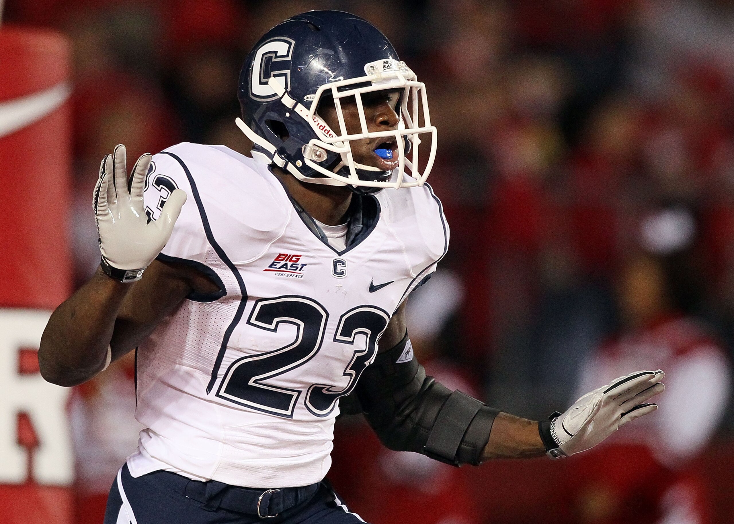 PISCATAWAY, NJ - OCTOBER 08:  Jordan Todman #23 of the Connecticut Huskies celebrates his second-quarter touchdown against the Rutgers Scarlet Knights at Rutgers Stadium on October 8, 2010 in Piscataway, New Jersey.  (Photo by Jim McIsaac/Getty Images)