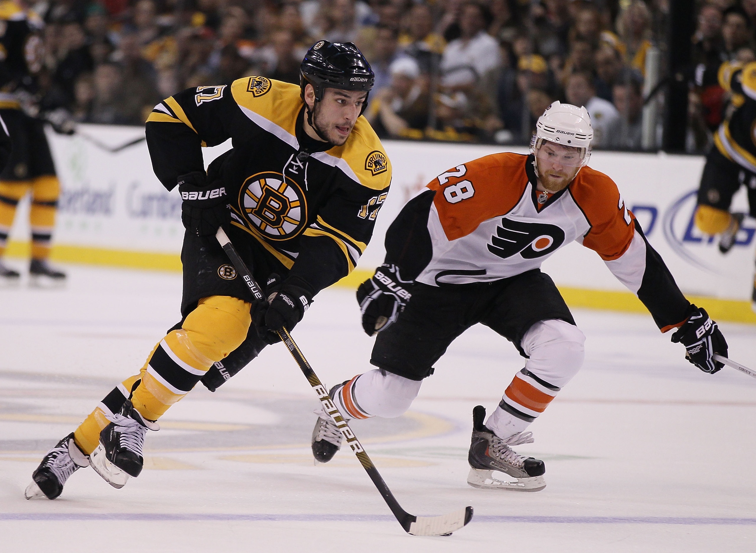 BOSTON - MAY 14:  Milan Lucic #17 of the Boston Bruins heads for the net as Claude Giroux #28 of the Philadelphia Flyers in Game Seven of the Eastern Conference Semifinals during the 2010 NHL Stanley Cup Playoffs at TD Garden on May 14, 2010 in Boston, Ma