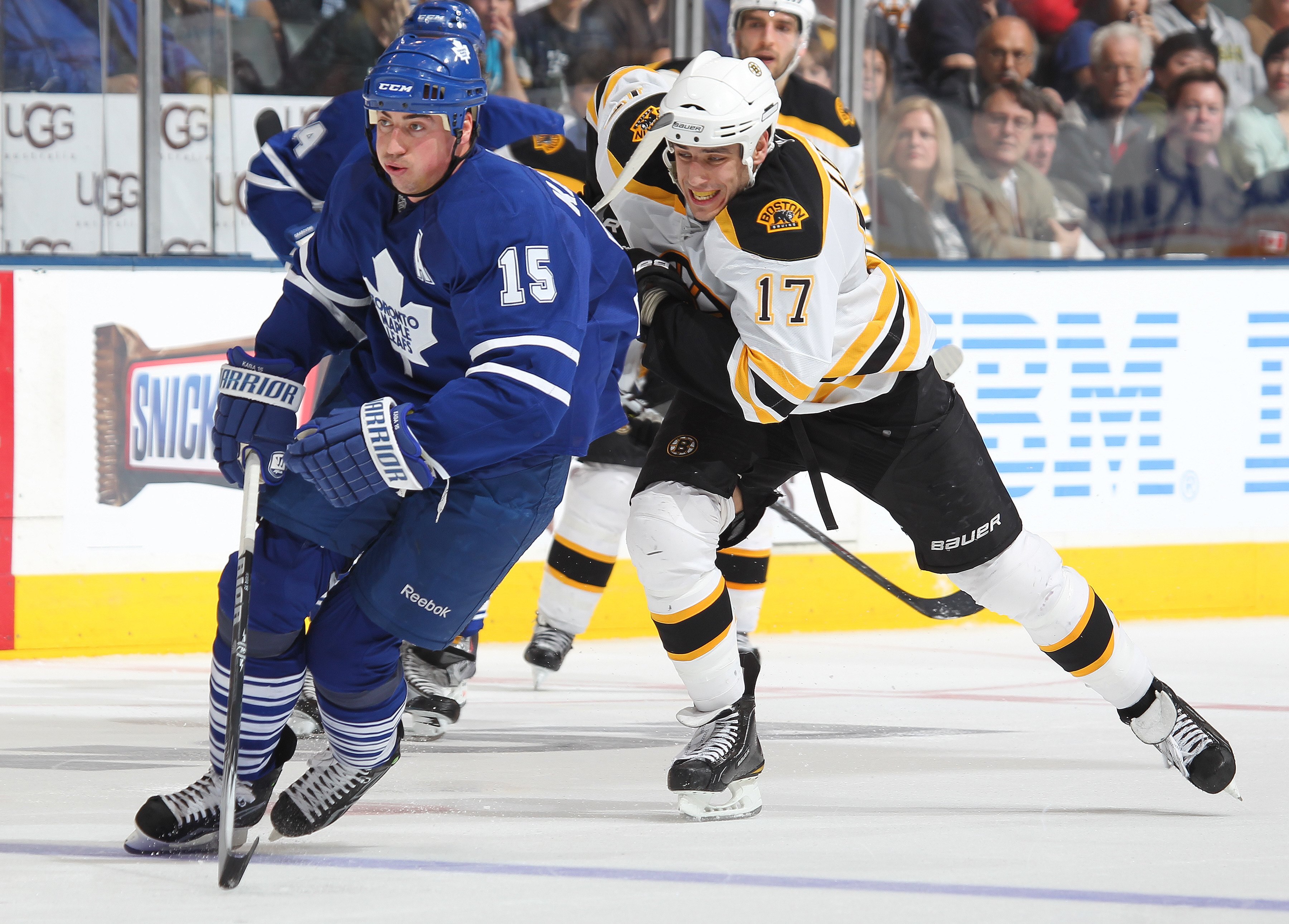 TORONTO, ON - APRIL 3:  Milan Lucic #17 of the Boston Bruins chases after Tomas Kaberle #15 of the Toronto Maple Leafs in a game on April 3, 2010 at the Air Canada Centre in Toronto, Ontario. The Bruins defeated the Leafs 2-1 in overtime. (Photo by Claus