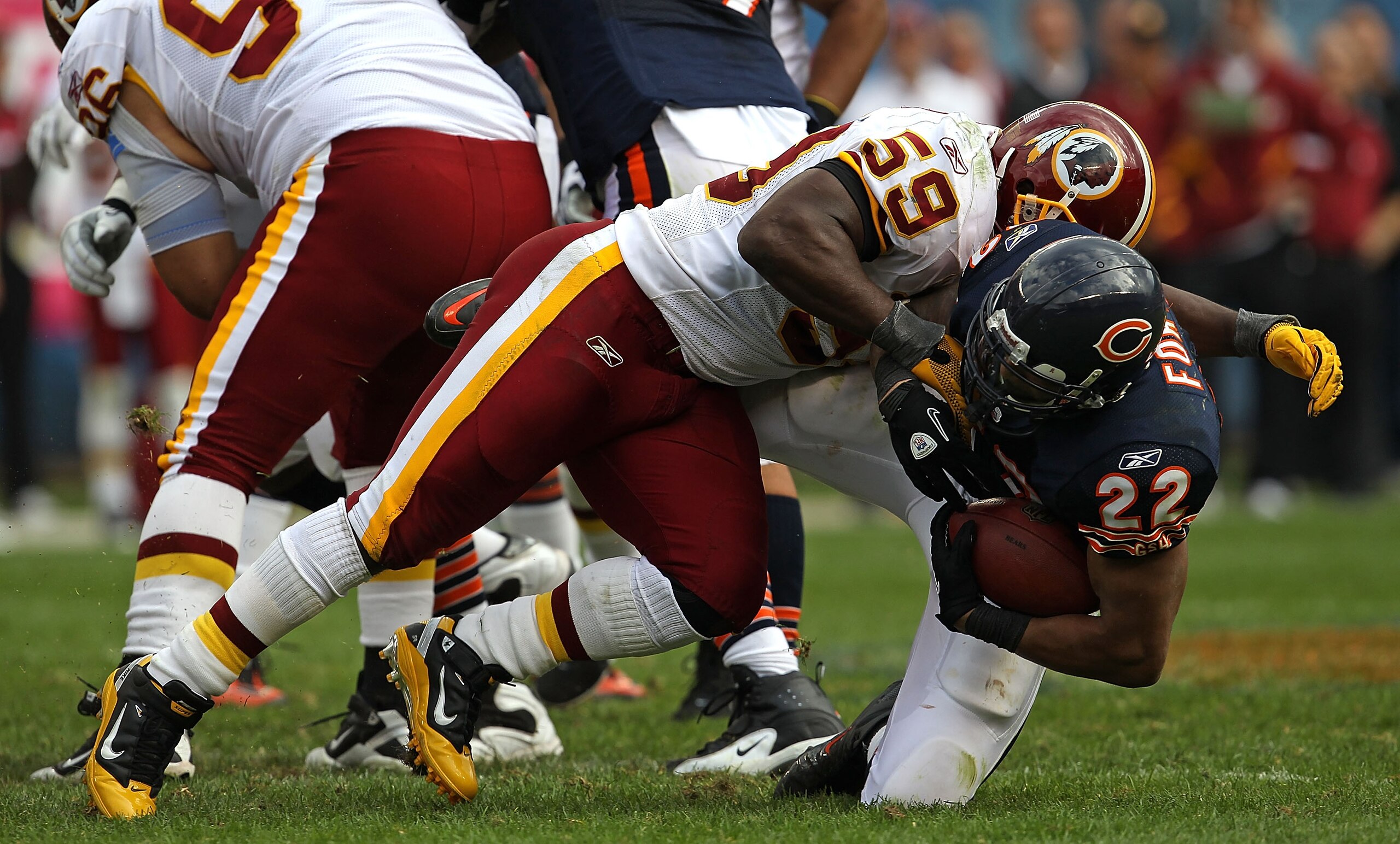 CHICAGO - OCTOBER 24: Matt Forte #22 of the Chicago Bears is dropped by London Fletcher #59 of the Washington Redskins at Soldier Field on October 24, 2010 in Chicago, Illinois. The Redskins defeated the Bears 17-14. (Photo by Jonathan Daniel/Getty Images