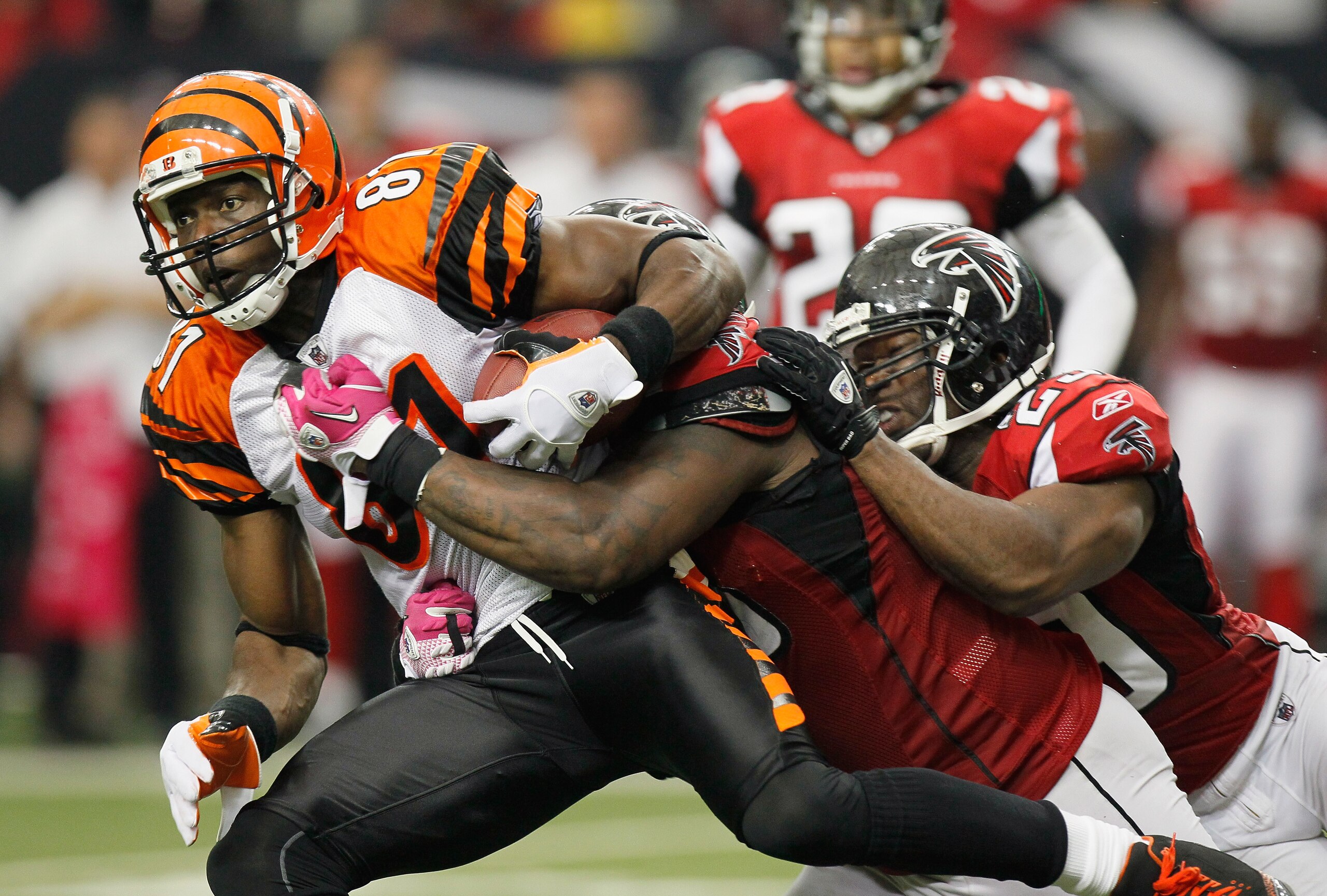 ATLANTA - OCTOBER 24:  Terrell Owens #81 of the Cincinnati Bengals is tackled by Jonathan Babineaux #95 and Brian Williams #29 of the Atlanta Falcons at Georgia Dome on October 24, 2010 in Atlanta, Georgia.  (Photo by Kevin C. Cox/Getty Images)