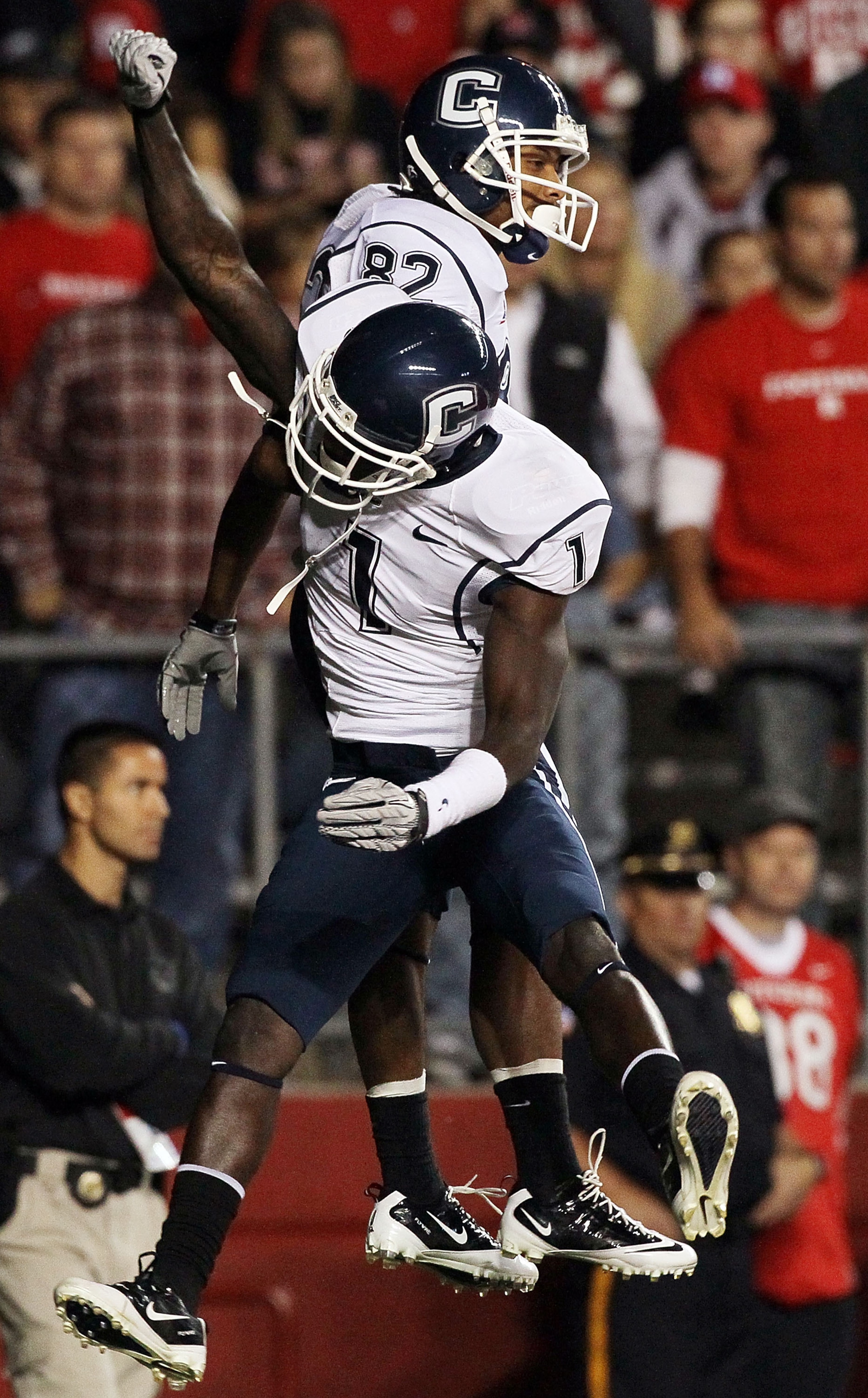 PISCATAWAY, NJ - OCTOBER 08:  Kashif Moore #82 of the Connecticut Huskies celebrates his second-quarter touchdown against the Rutgers Scarlet Knights with teammate Dwayne Difton #1 at Rutgers Stadium on October 8, 2010 in Piscataway, New Jersey.  (Photo b