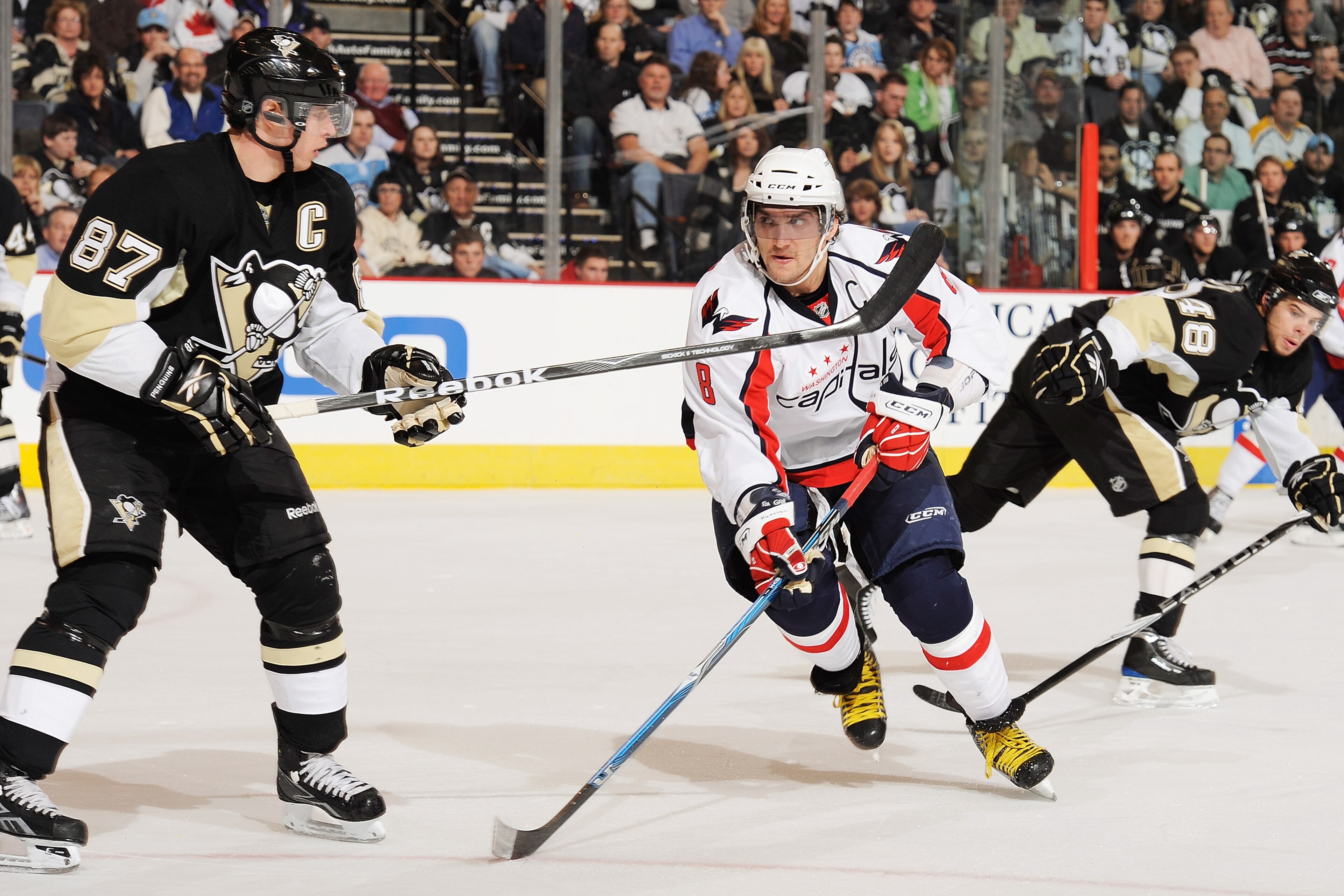 PITTSBURGH - JANUARY 21:  Forward Alex Ovechkin #8 of the Washington Capitals lines up forward Sidney Crosby #87 of the Pittsburgh Penguins for a check on January 21, 2010 at Mellon Arena in Pittsburgh, Pennsylvania. Ovechkin had two goals and an assist i
