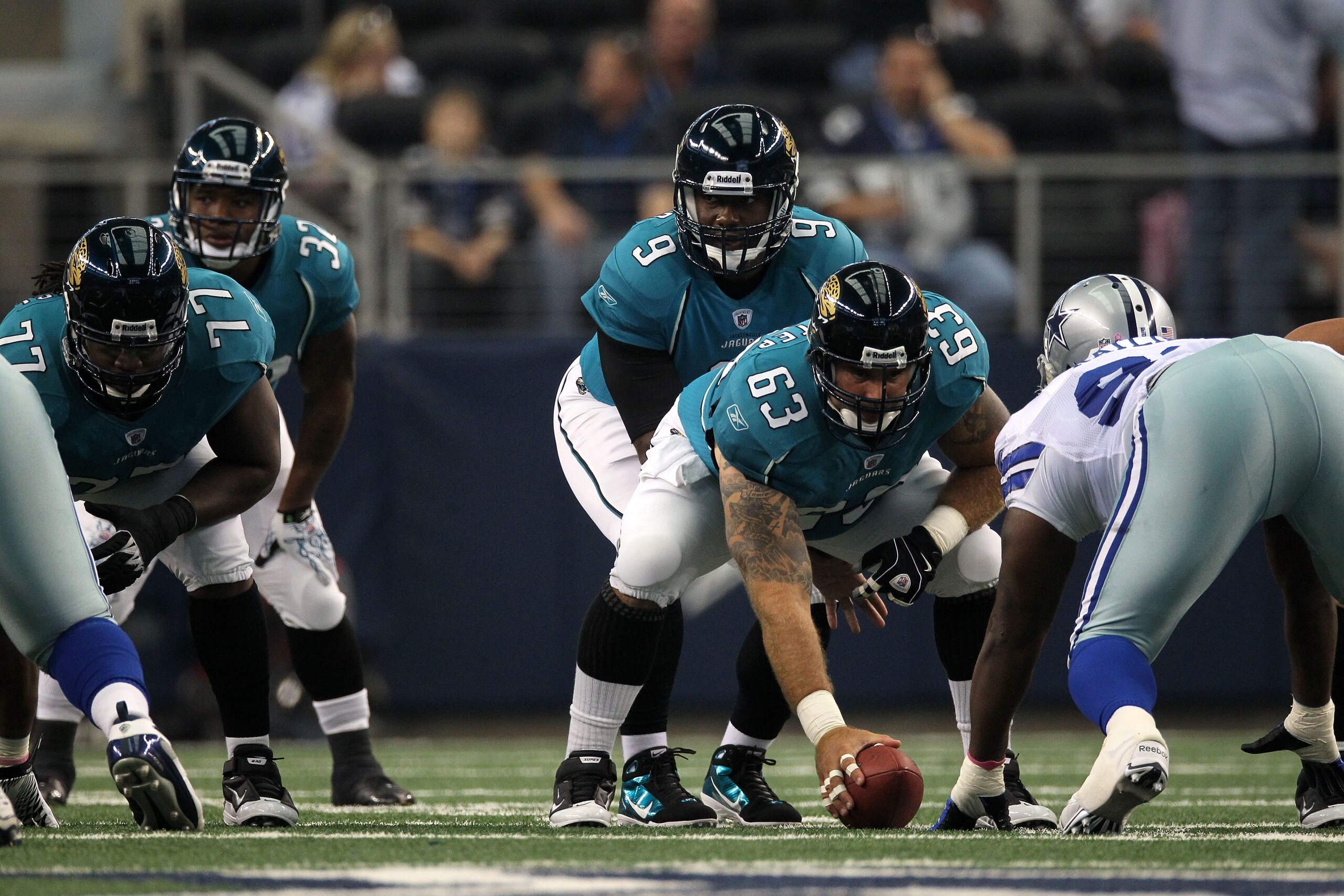 ARLINGTON, TX - OCTOBER 31:  David Garrard #9 of the Jacksonville Jaguars calls signals out at the line of scrimmage as he stands under center Brad Meester #63 against the Dallas Cowboys at Cowboys Stadium on October 31, 2010 in Arlington, Texas.  (Photo