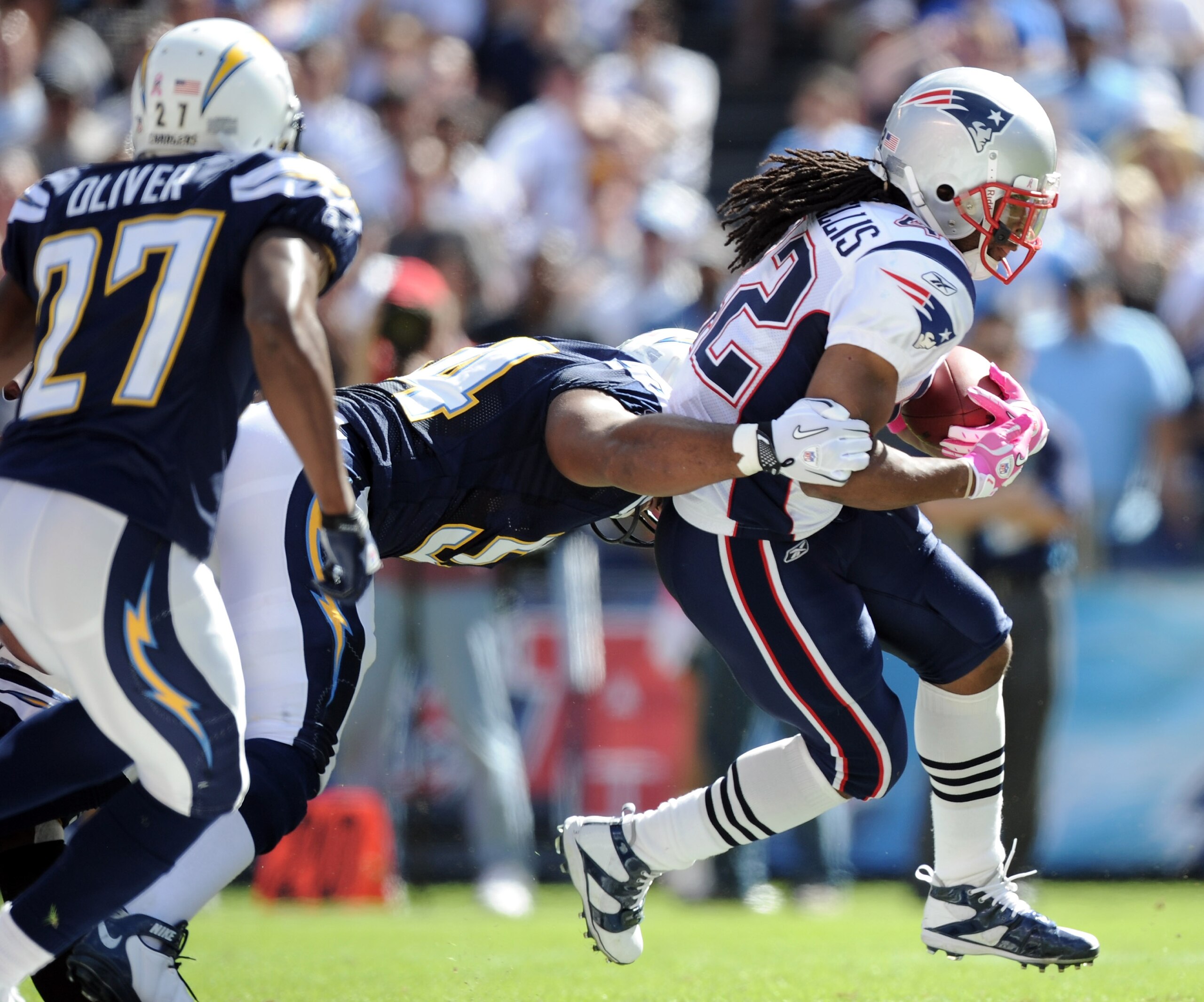 SAN DIEGO - OCTOBER 24:  BenJarvus Green-Ellis #42 of the New England Patriots is tackled by Stephen Cooper #54 and chased by Paul Oliver #27  of theSan Diego Chargers at Qualcomm Stadium on October 24, 2010 in San Diego, California.  (Photo by Harry How/