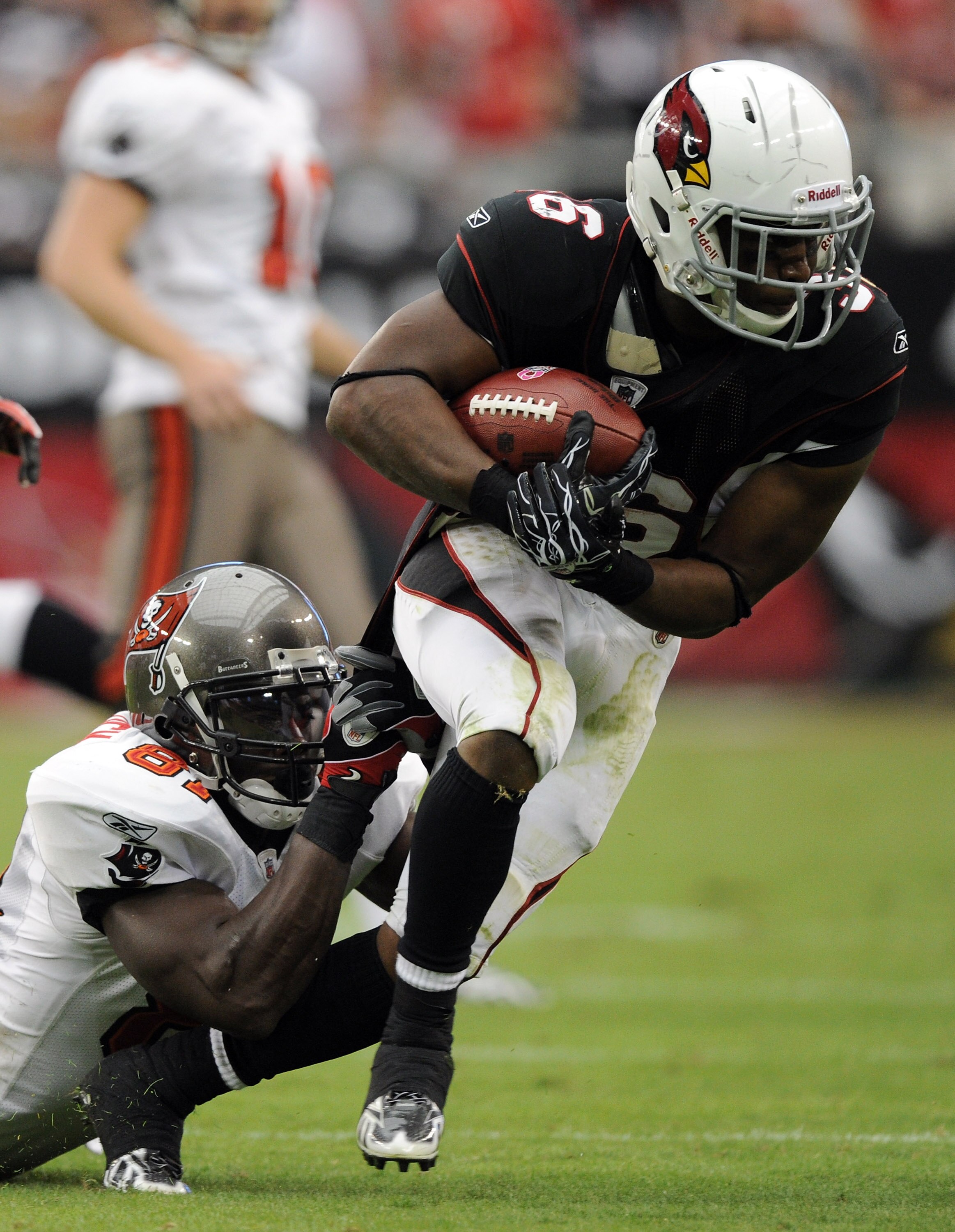 GLENDALE, AZ - OCTOBER 31:  LaRod Stephens-Howling #36 of the Arizona Cardinals is tackled by Michael Spurlock #81 of the Tampa Bay Buccaneers at University of Phoenix Stadium on October 31, 2010 in Glendale, Arizona.  (Photo by Harry How/Getty Images)