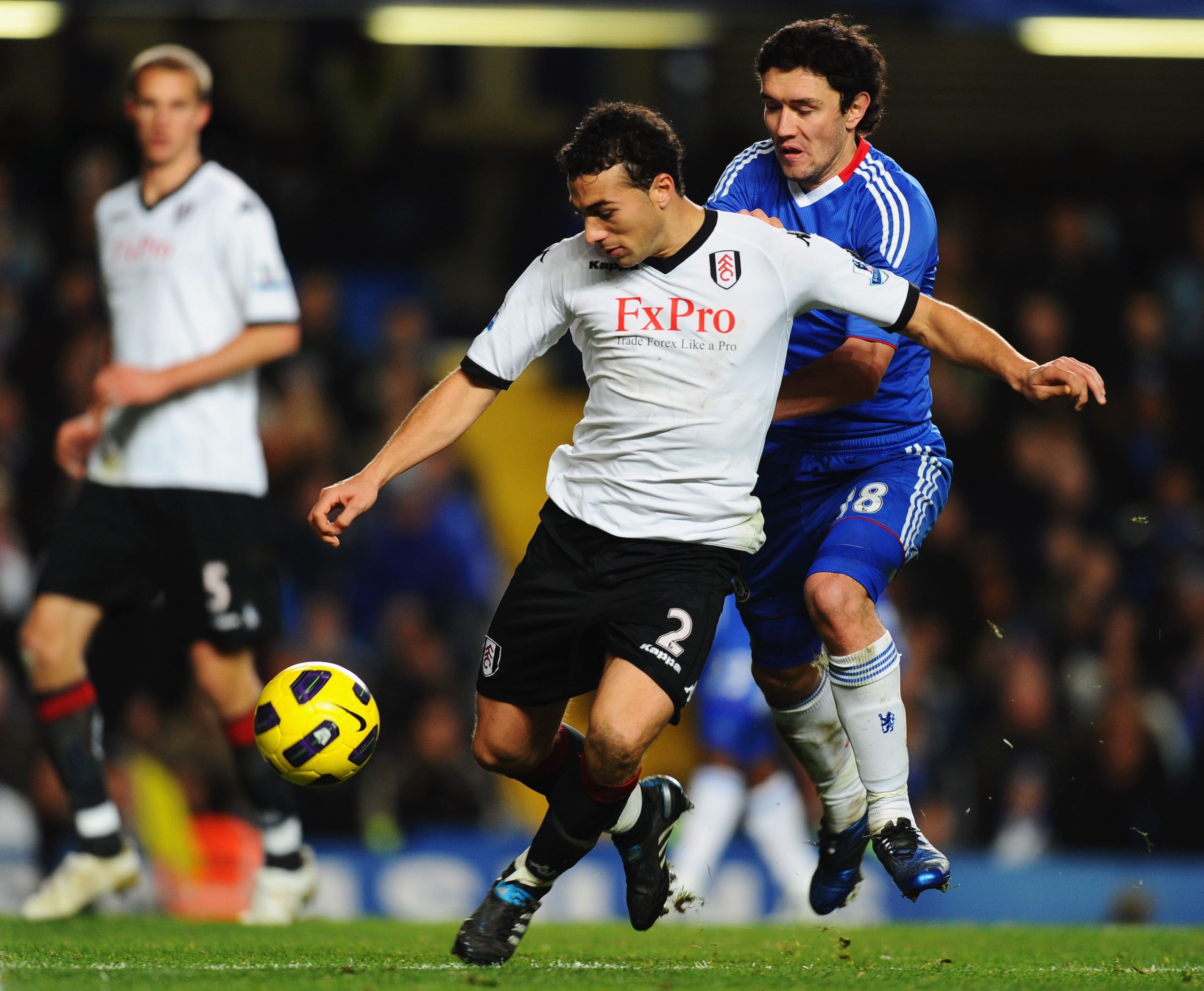 LONDON, ENGLAND - NOVEMBER 10:  Yuriy Zhirkov of Chelsea battles with Stephen Kelly of Fulham during the Barclays Premier League match between Chelsea and Fulham at Stamford Bridge on November 10, 2010 in London, England.  (Photo by Mike Hewitt/Getty Imag