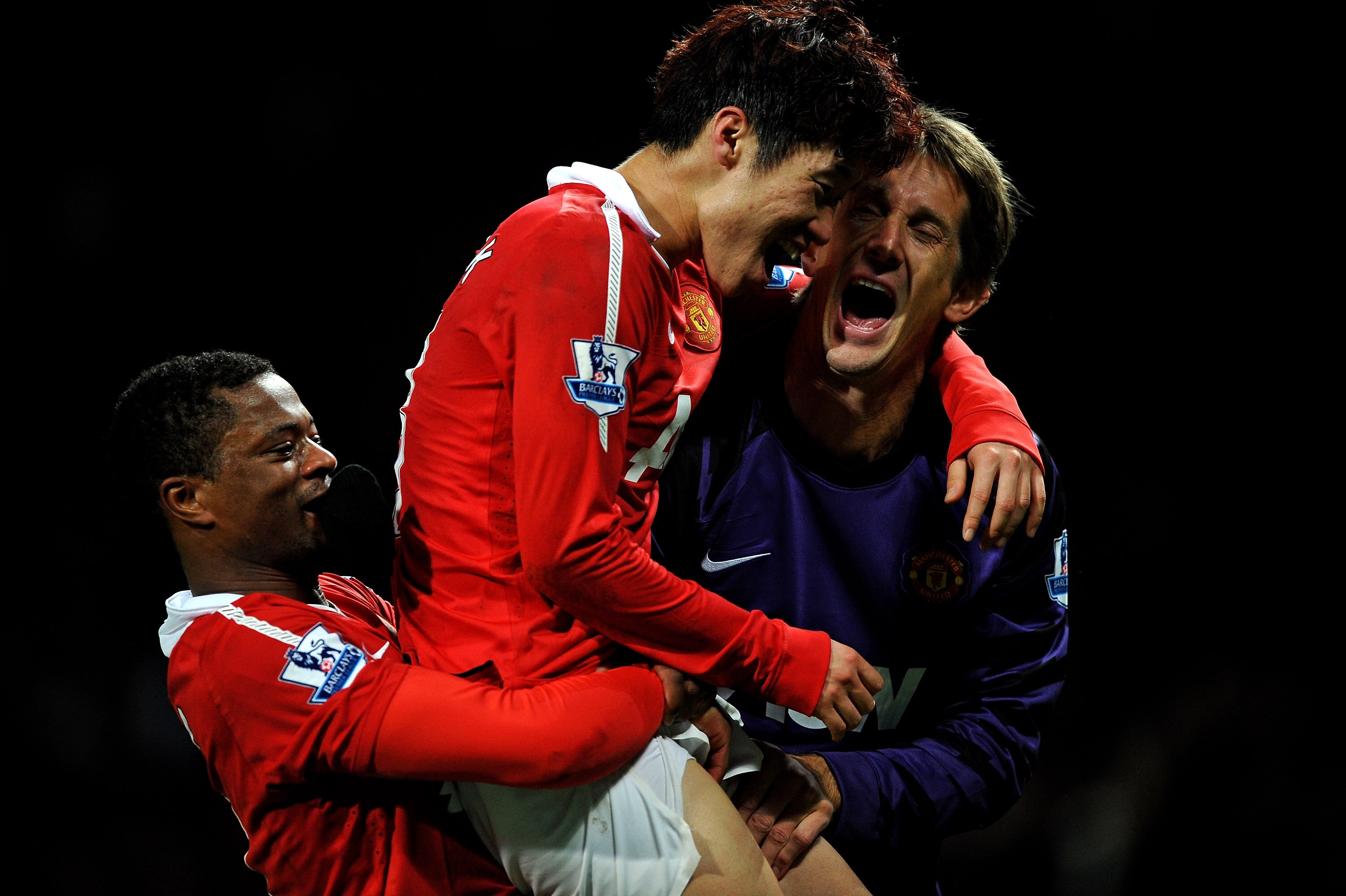 MANCHESTER, ENGLAND - NOVEMBER 06:  Ji-Sung Park of Manchester United celebrates scoring the winning goal with team mates Patrice Evra (L) and Edwin van der Sar (R) during the Barclays Premier League match between Manchester United and Wolverhampton Wande